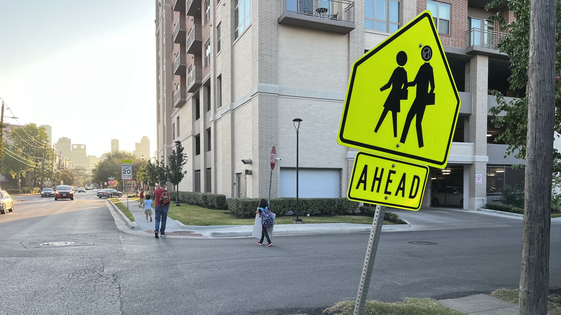 A lime green sign marks where people cross the street in Montrose