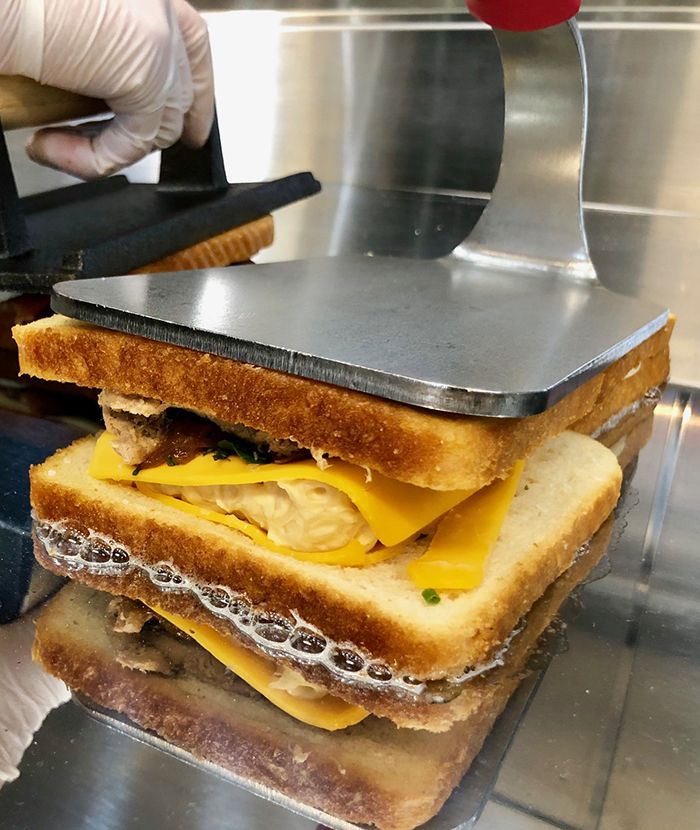 making grilled cheese at papi queso charlotte