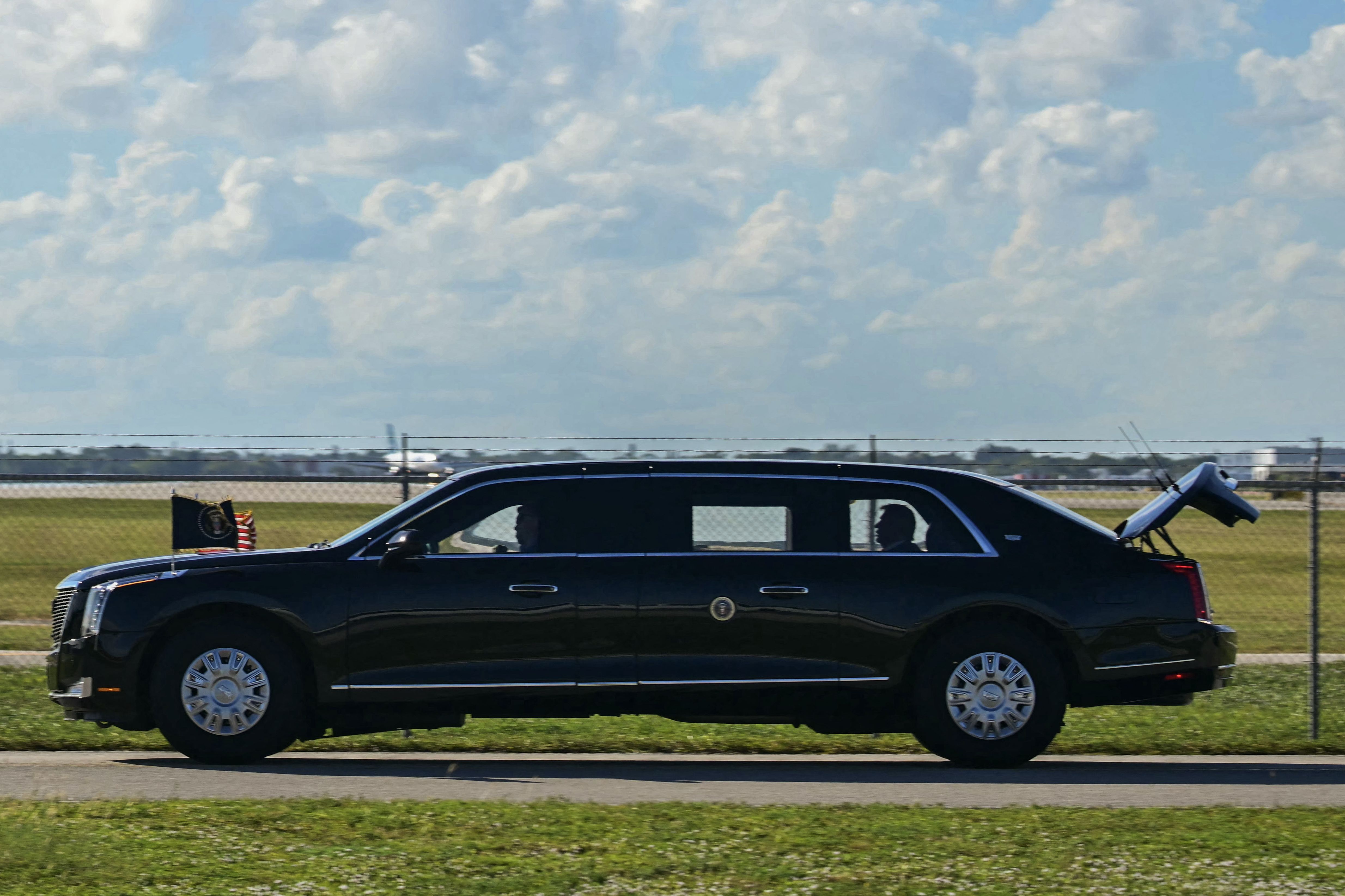 TOPSHOT - The US President's official vehicle known as "The Beast", drives with its trunk open, as US President Donald Trump's motorcade travels to Palm Beach International Airport in West Palm Beach, Florida, on November 9, 2025. Trump is returning to Washington DC after spending part of the weeken