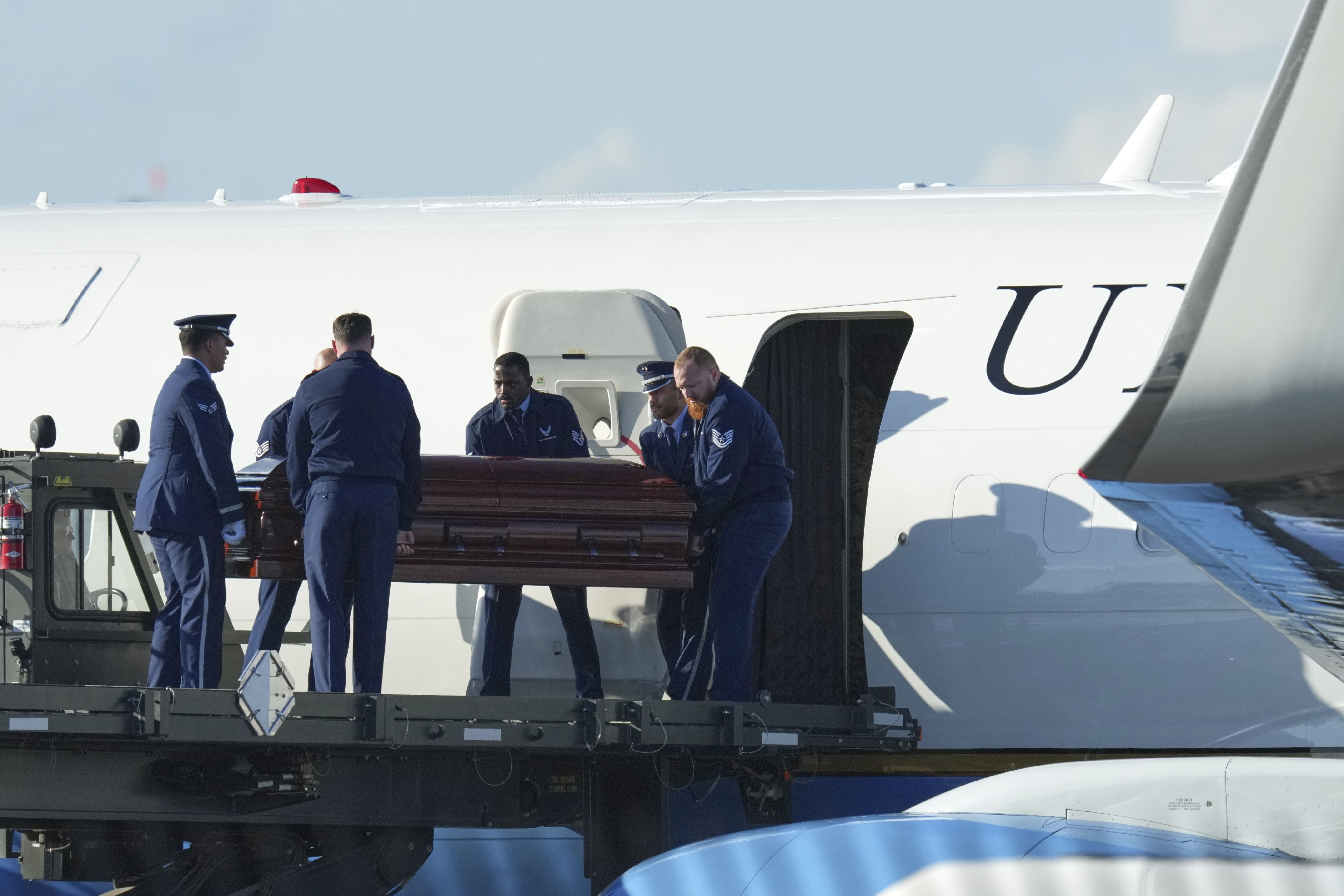 The casket containing the body of Charlie Kirk is carried off Air Force Two at Phoenix Sky Harbor International Airport yesterday.