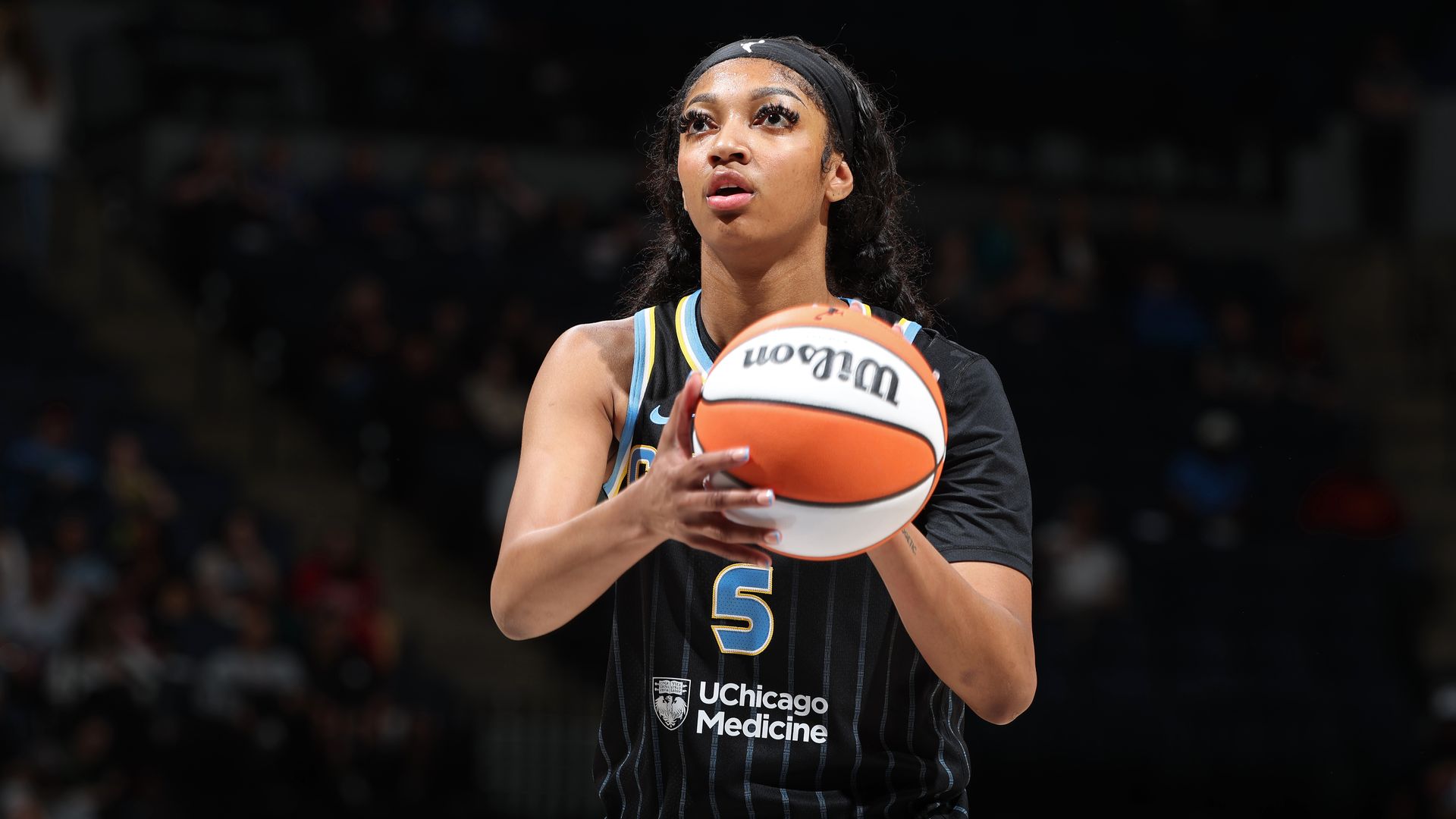 Photo of a woman shooting a basketball 