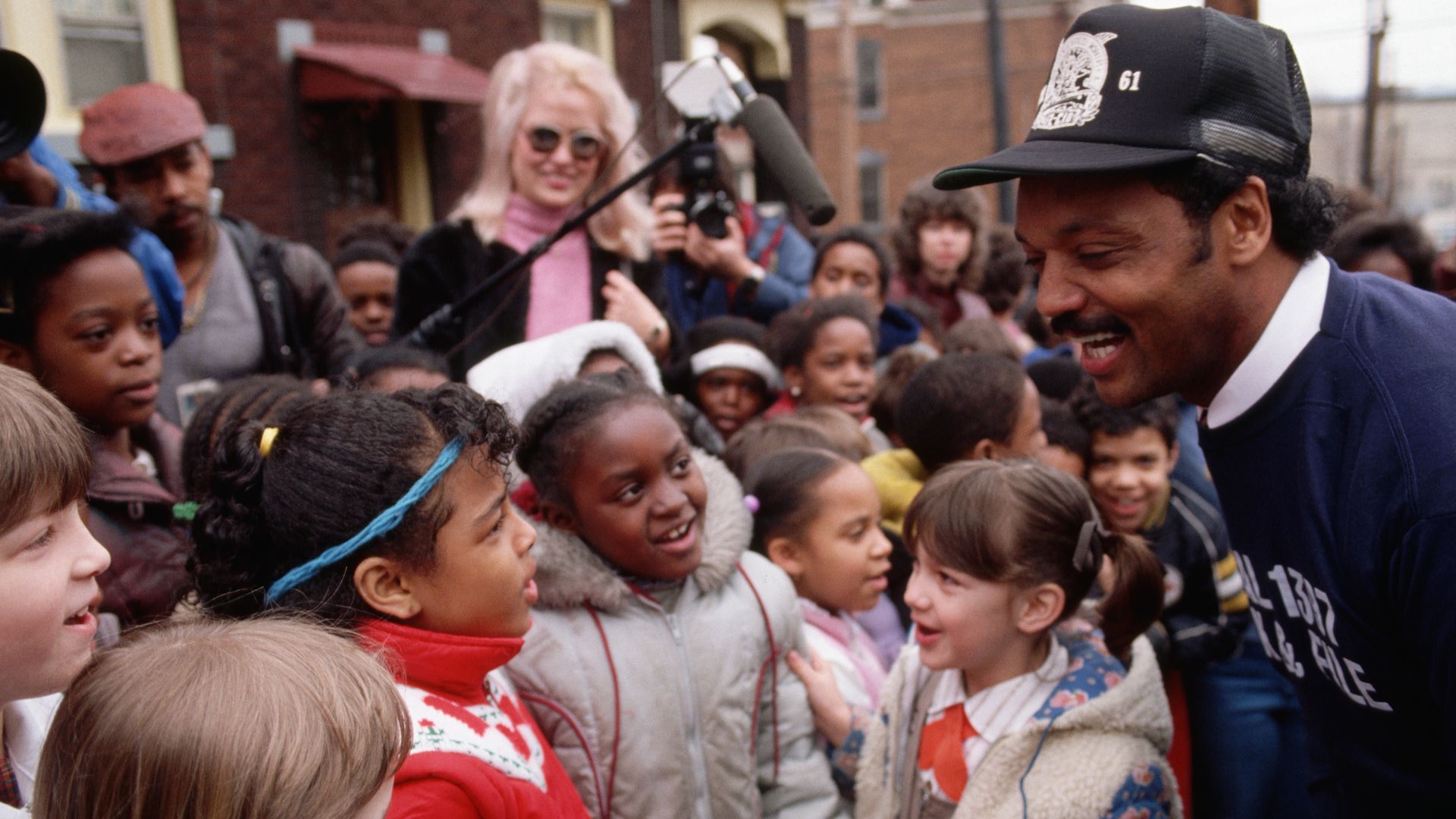 Jesse Jackson, Baptist minister and candidate for the Democratic presidential nomination in 1984, talks with young children while campaigning in Pittsburgh. 