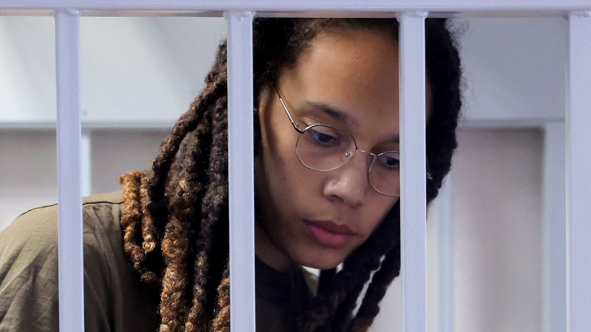 US basketball player Brittney Griner stands in a defendants' cage before a court hearing during her trial on charges of drug smuggling, in Khimki, outside Moscow on August 2.