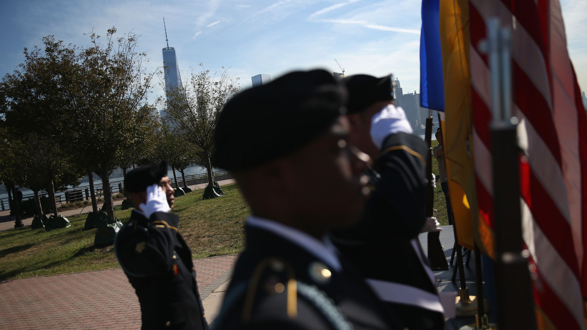National Guard members saluting the flag. 