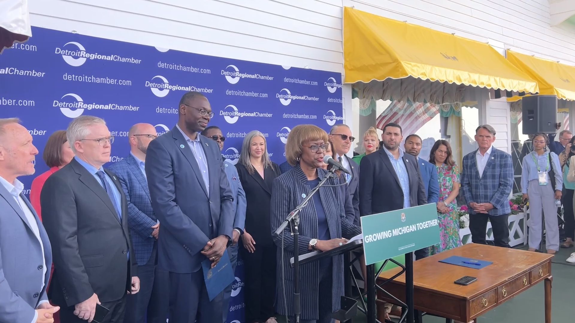 Shirley Stancato stands at the podium in front of Lt. Gov. Garlin Gilchrist on Mackinac Island's Grand Hotel earlier this year to announced the creation of the council. Photo: Samuel Robinson/Axios