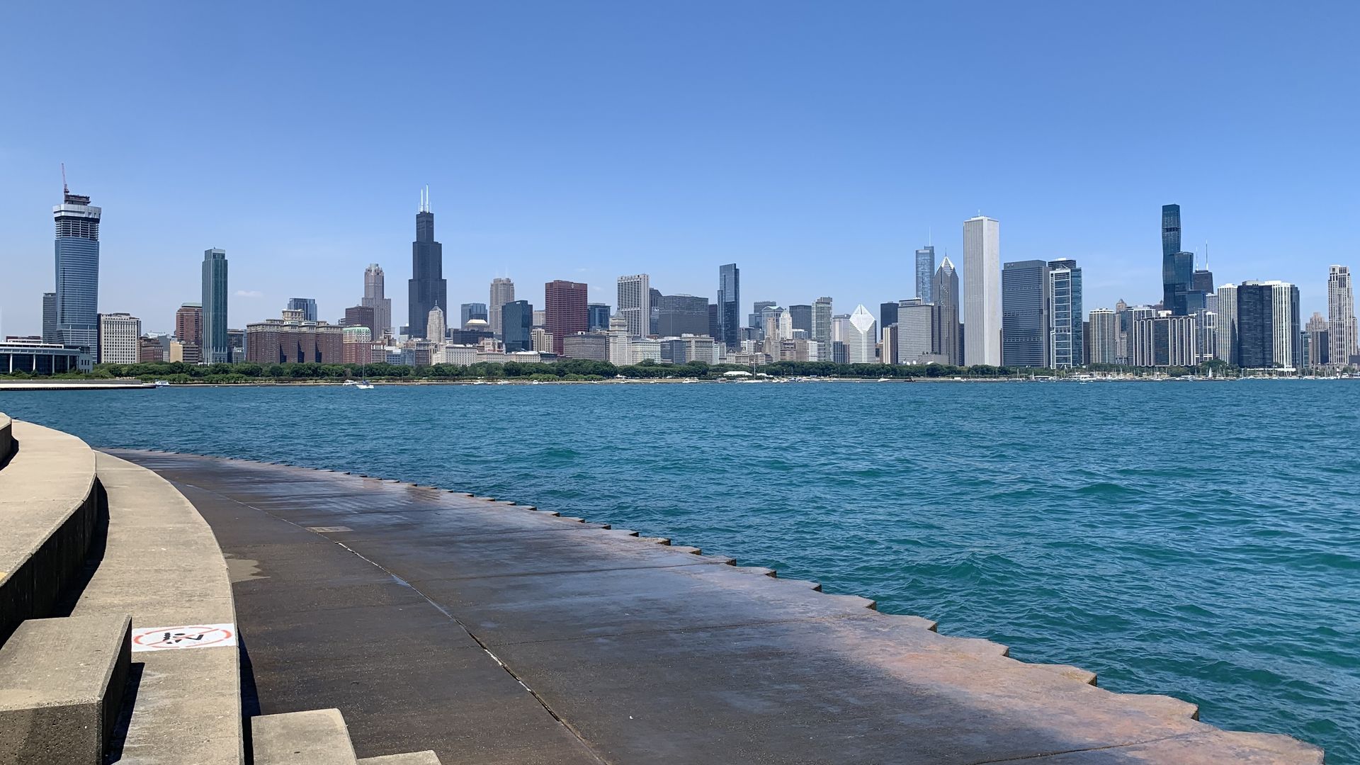 Photo of a skyline view with a lake in front of it. 