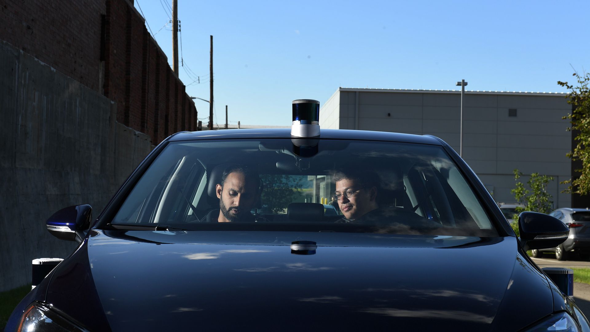 image of two engineers in a car equipped with lidar