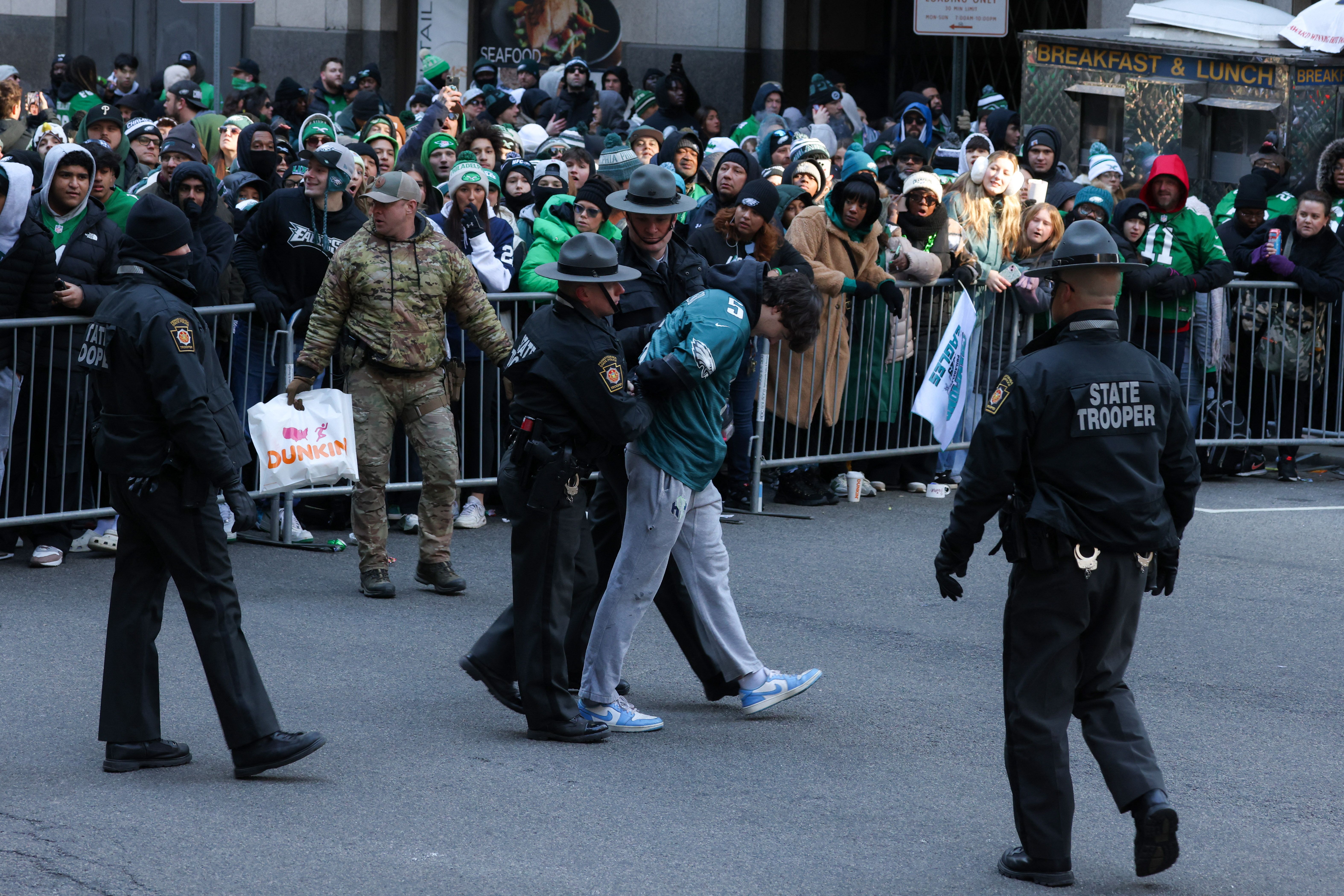 An Eagles fan being arrested by state trooopers.