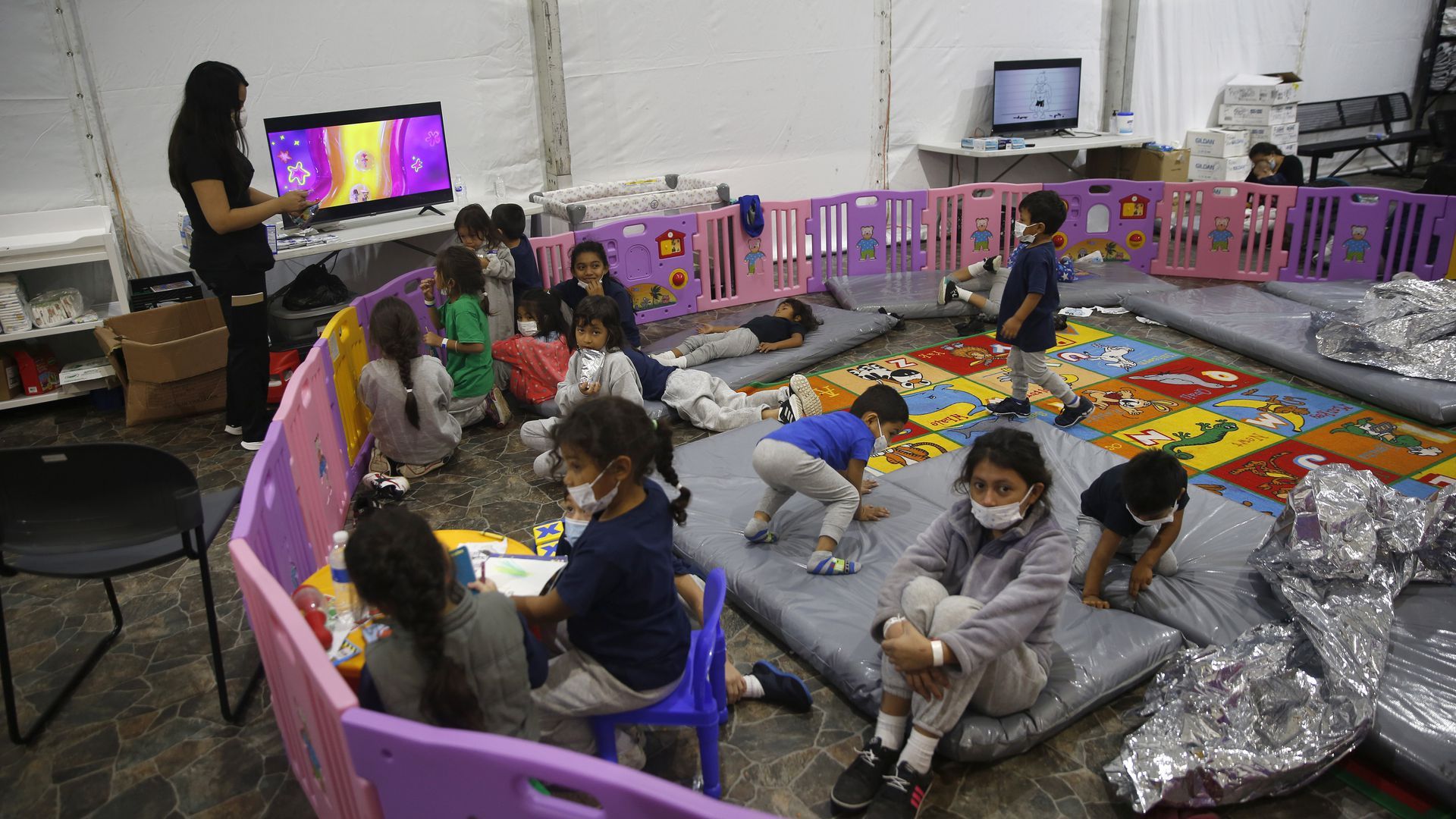Monitored by a caretaker, young unaccompanied immigrants, ages 3-9, in a playpen at a Homeland Security holding facility in Donna, Texas, last month. Photo: Dario Lopez-Mills - Pool/Getty Images