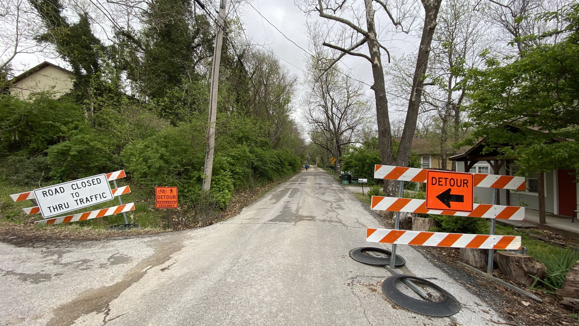 A detour sign points up a road.