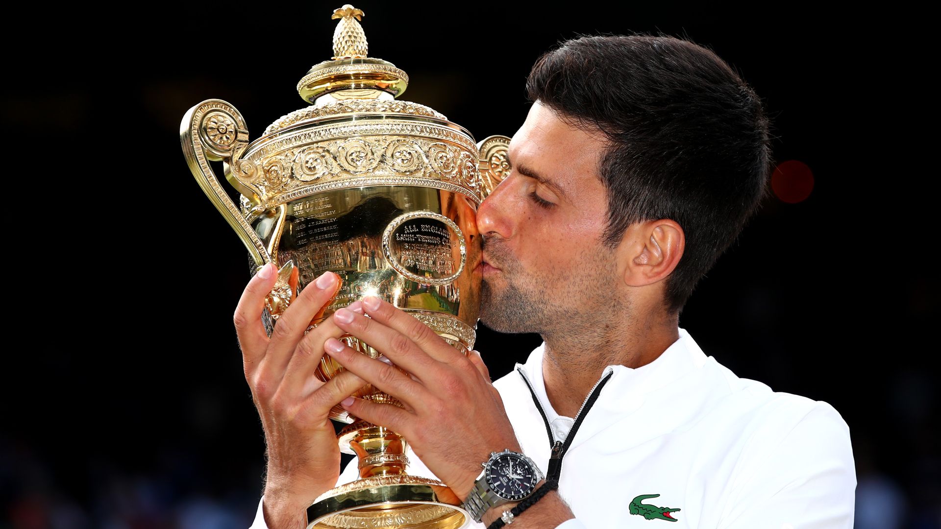 Novak Djokovic kisses the Wimbledon trophy