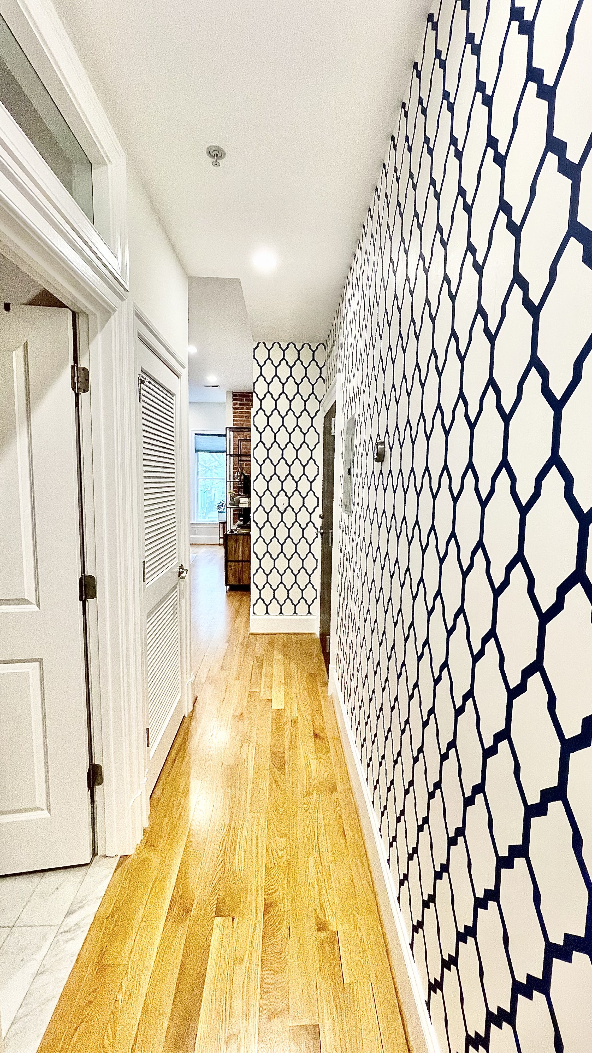 navy and white wallpaper from farrow and ball used in a hallway