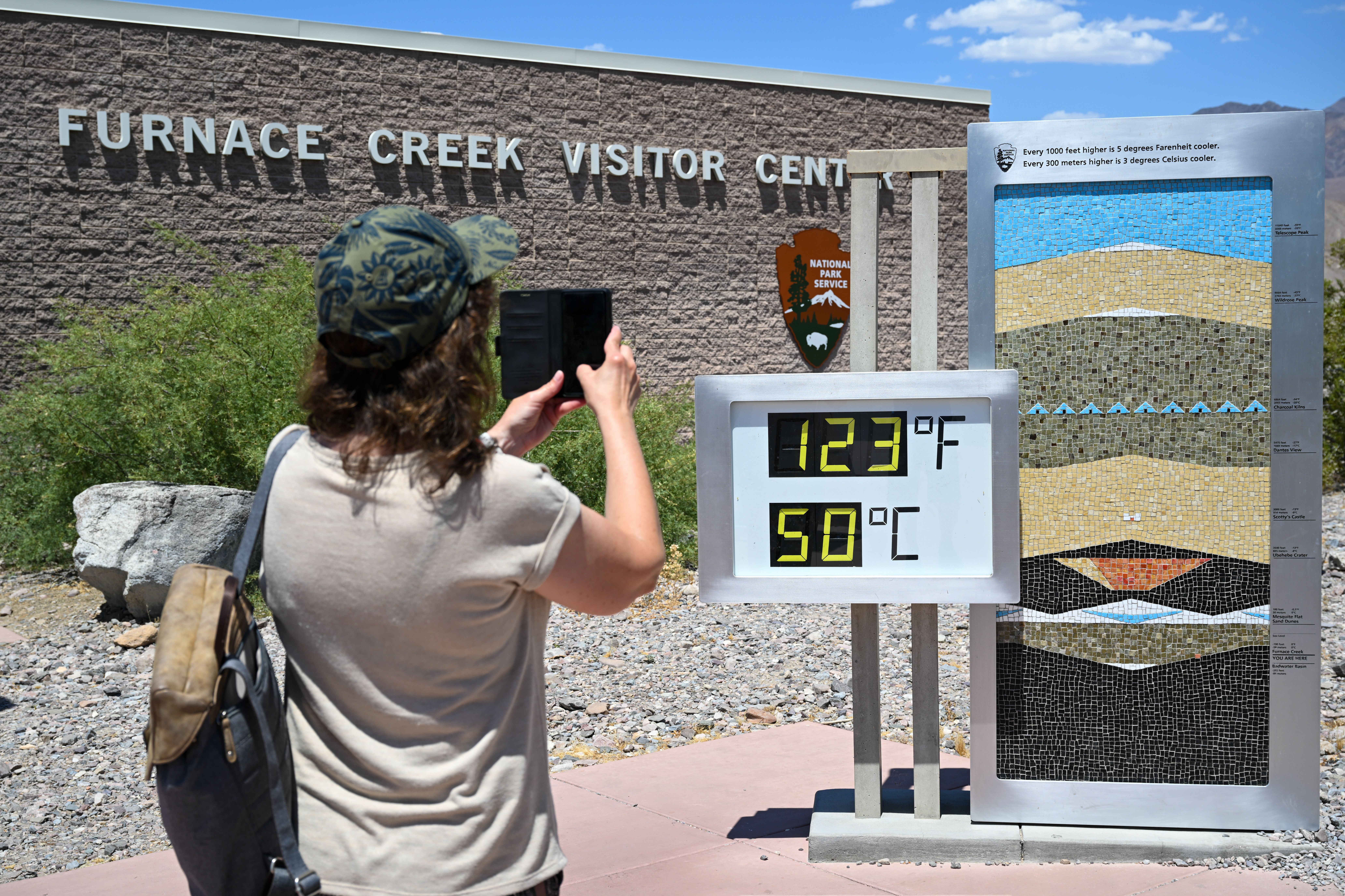 A visitor takes a photo of thermometer in Death Valley yesterday. Photo: Tayfun Coskun/Anadolu via Getty Images