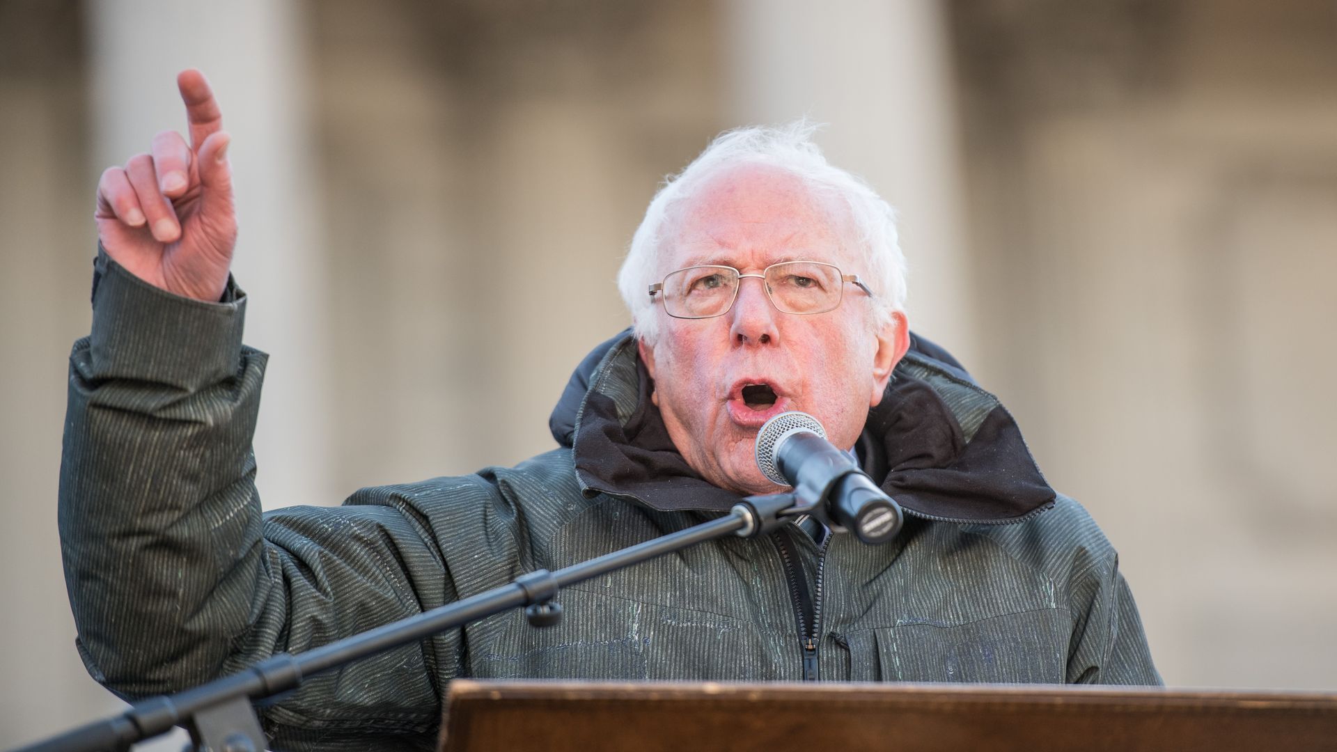 This is a photo of Bernie Sanders giving a speech and pointing in the air