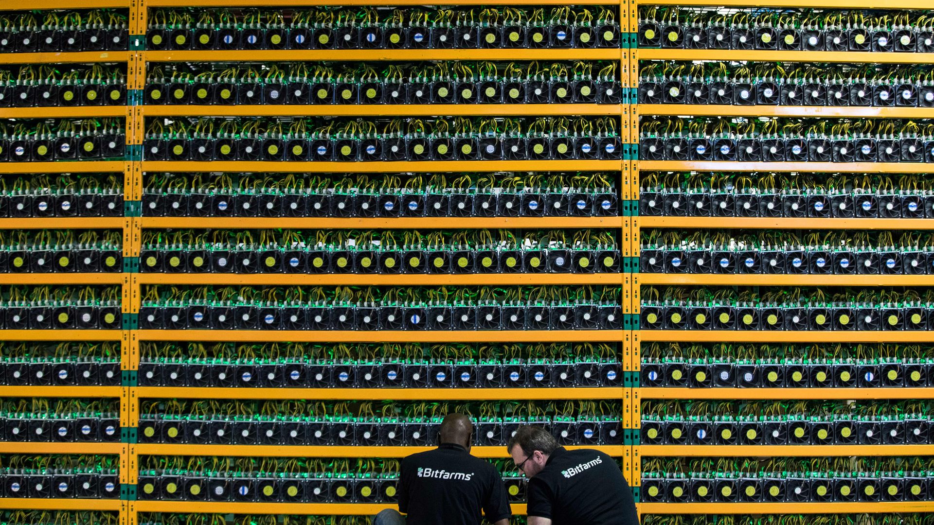 workers and servers at a bitcoin mining facility