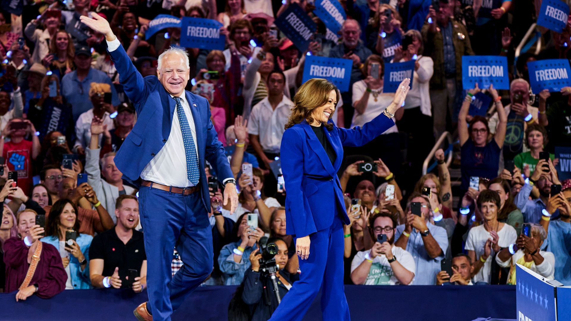 US Vice President Kamala Harris, right, and Tim Walz, governor of Minnesota and Democratic vice-presidential nominee, during a campaign event at Fiserv Forum in Milwaukee, Wisconsin, US, on Tuesday, Aug. 20, 2024.
