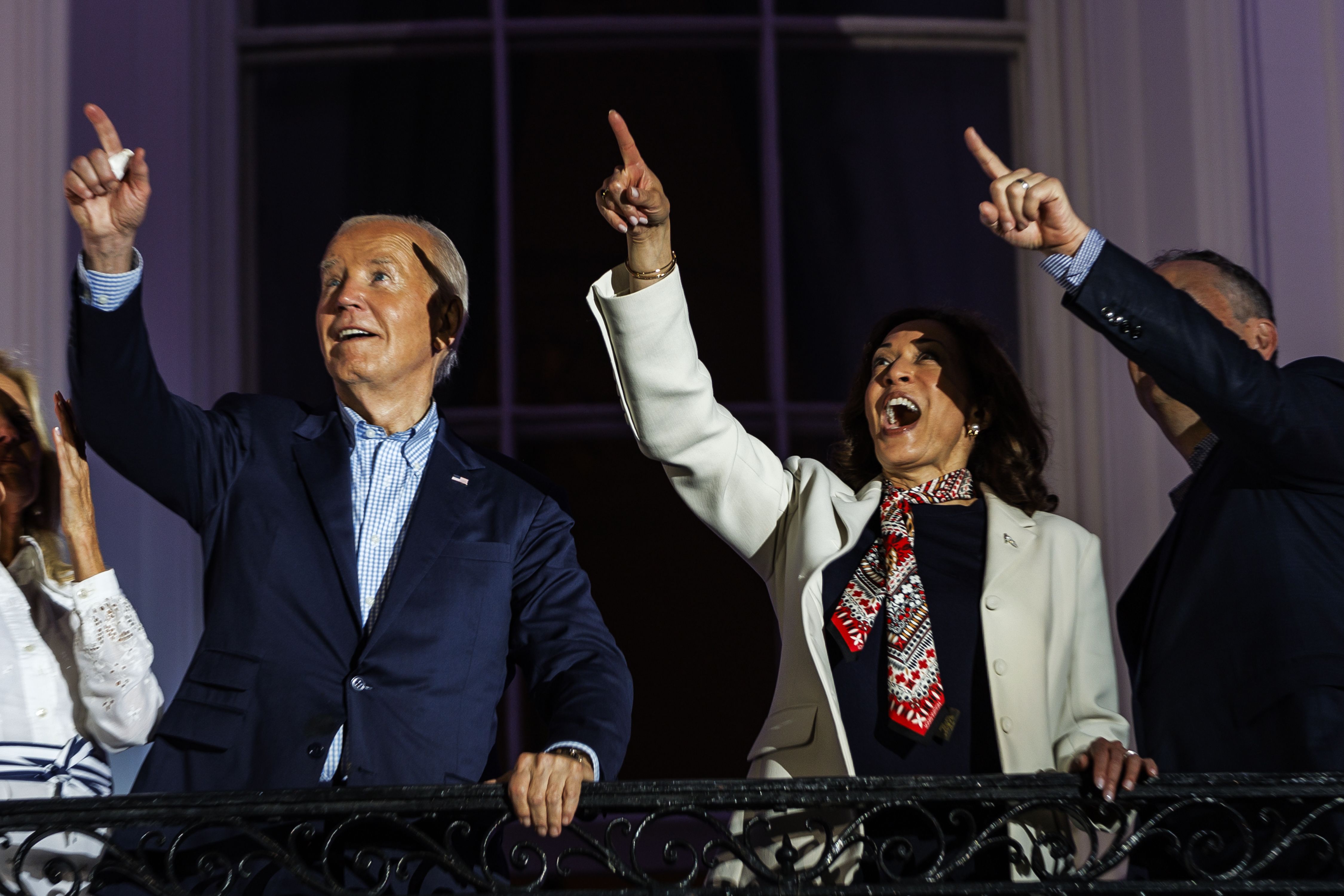 : President Joe Biden, Vice President Kamala Harris, and Second Gentleman Doug Emhoff react to the fireworks on the National Mall from the White House balcony during a 4th of July event on the South Lawn of the White House on July 4, 2024 in Washington, DC.