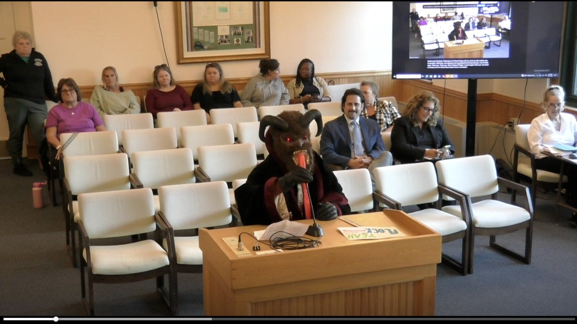 A person dressed as Krampus who goes by Krampus speaks at a Billerica Select Board Meeting against Flock on Sept. 21, 2026.