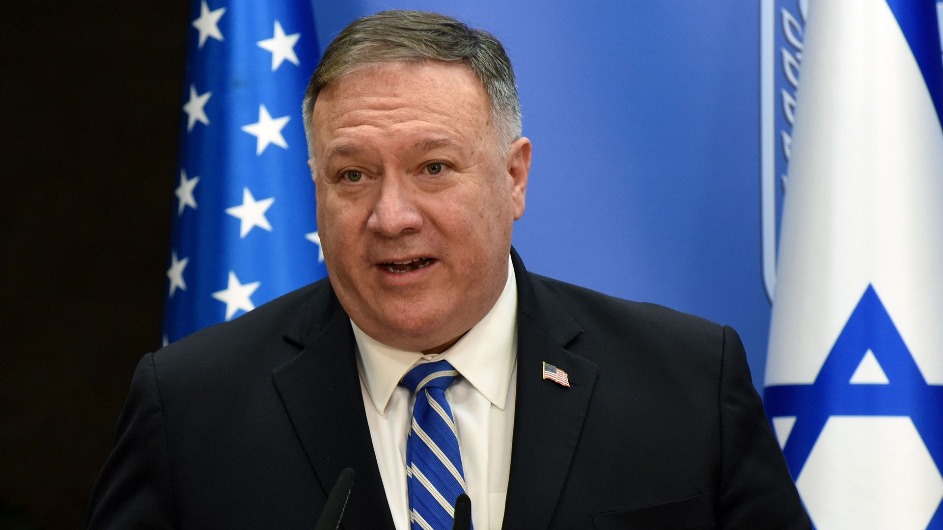 Mike Pompeo wears a suit and tie 