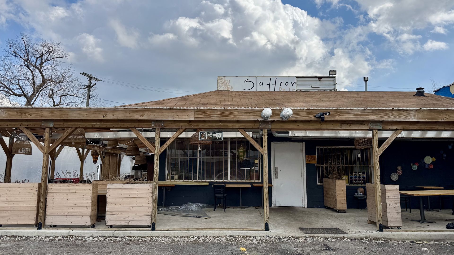 A restaurant storefront with a wooden awning