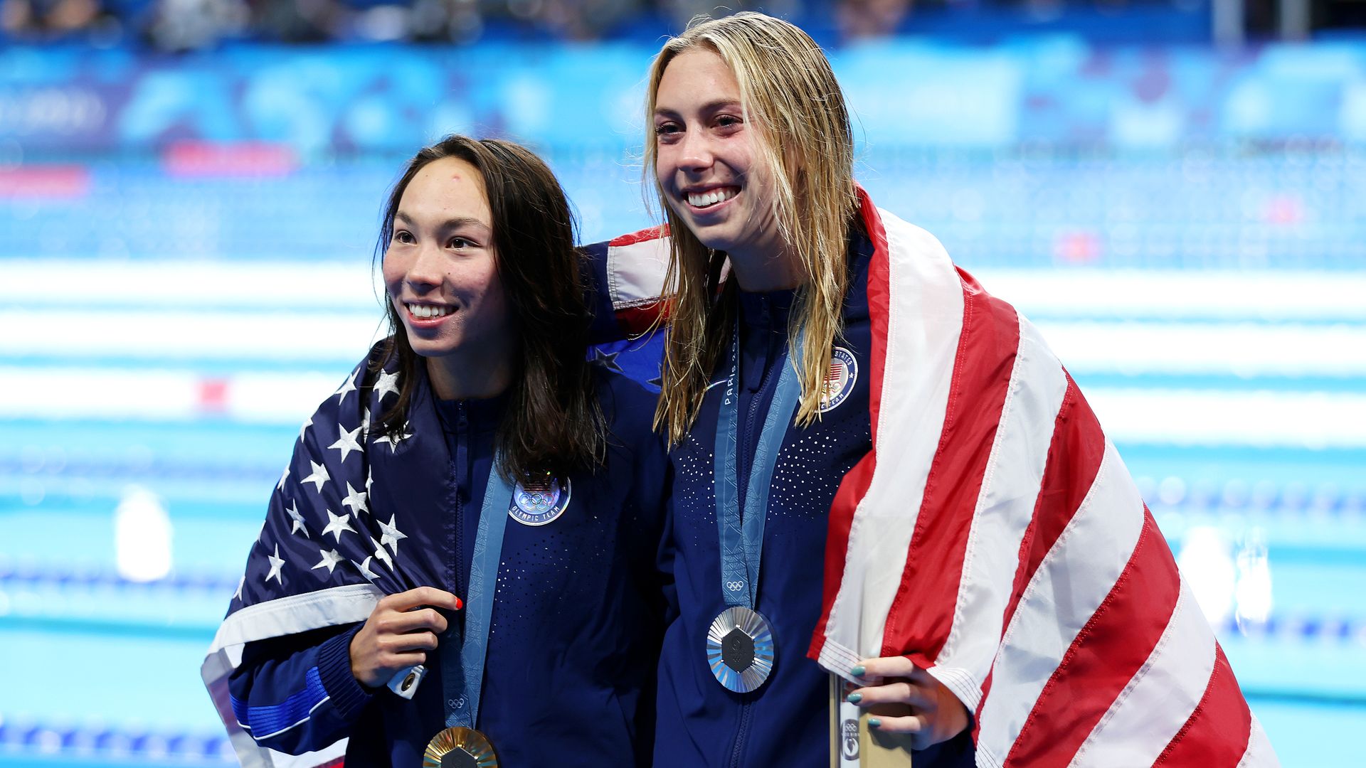 Gold Medalist Torri Huske (L) and Silver Medalist Gretchen Walsh (R) of Team United States pose following the Swimming medal ceremony after the Women’s 100m Butterfly Final on day two of the Olympic Games Paris 2024 at Paris La Defense Arena on July 28, 2024 in Nanterre, France. 