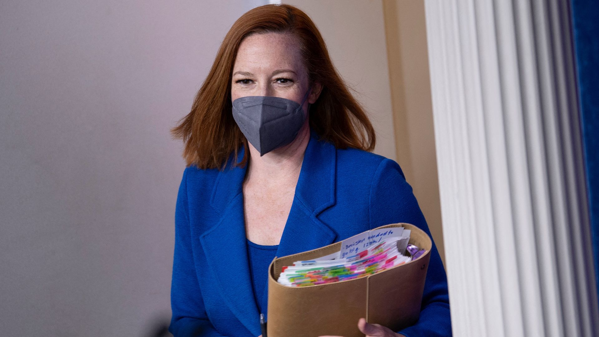 White House Press Secretary Jen Psaki is seen toting a tabbed binder as she arrives for her daily briefing.