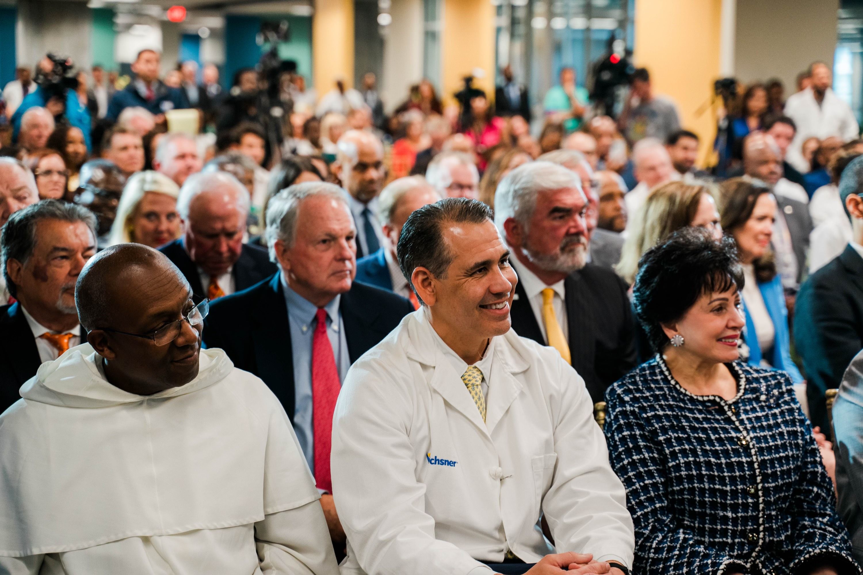 Photo shows Leonardo Seoane sitting next to Gayle Benson.