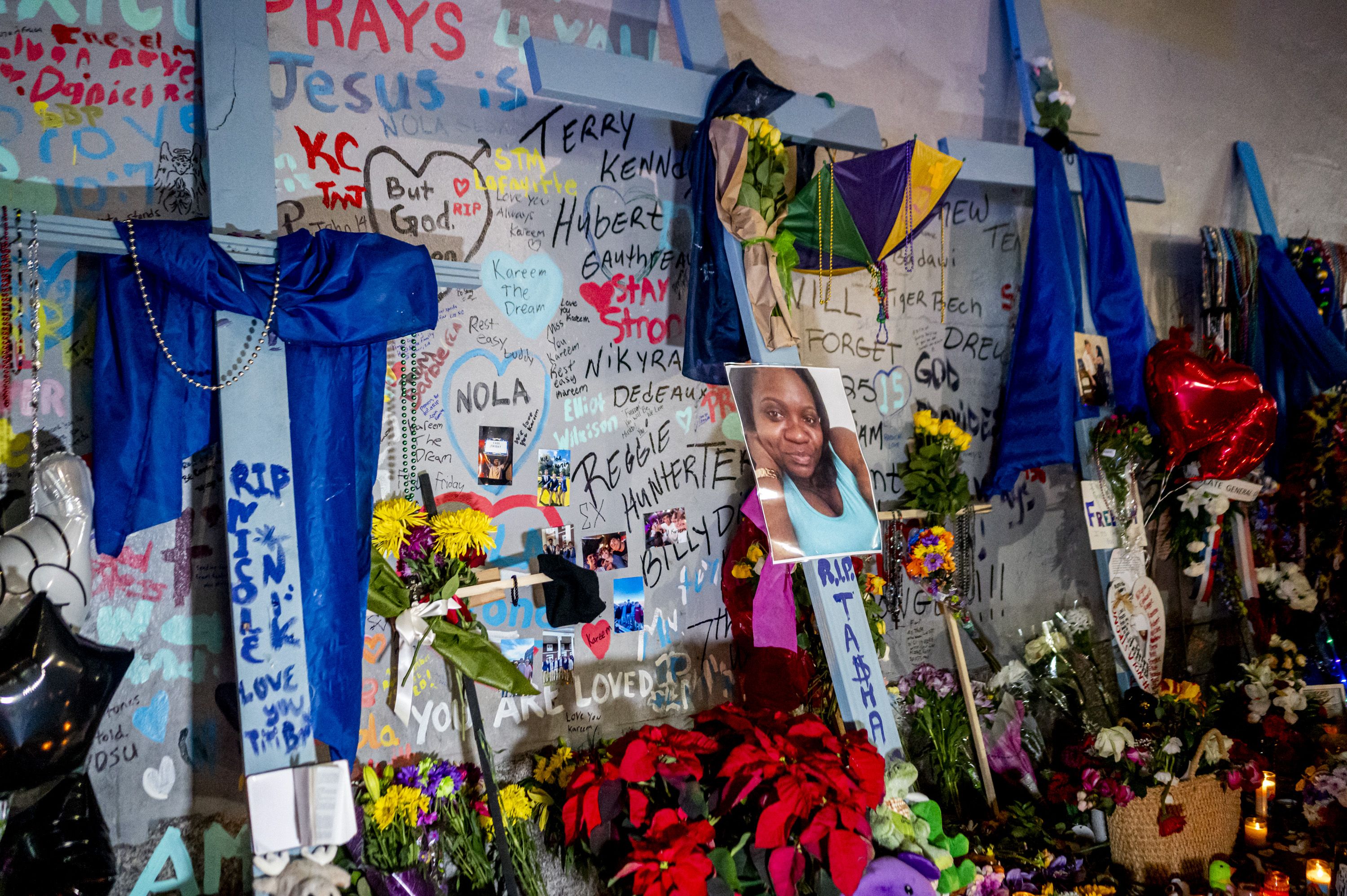 Photo shows crosses and photos from a memorial on Bourbon Street.