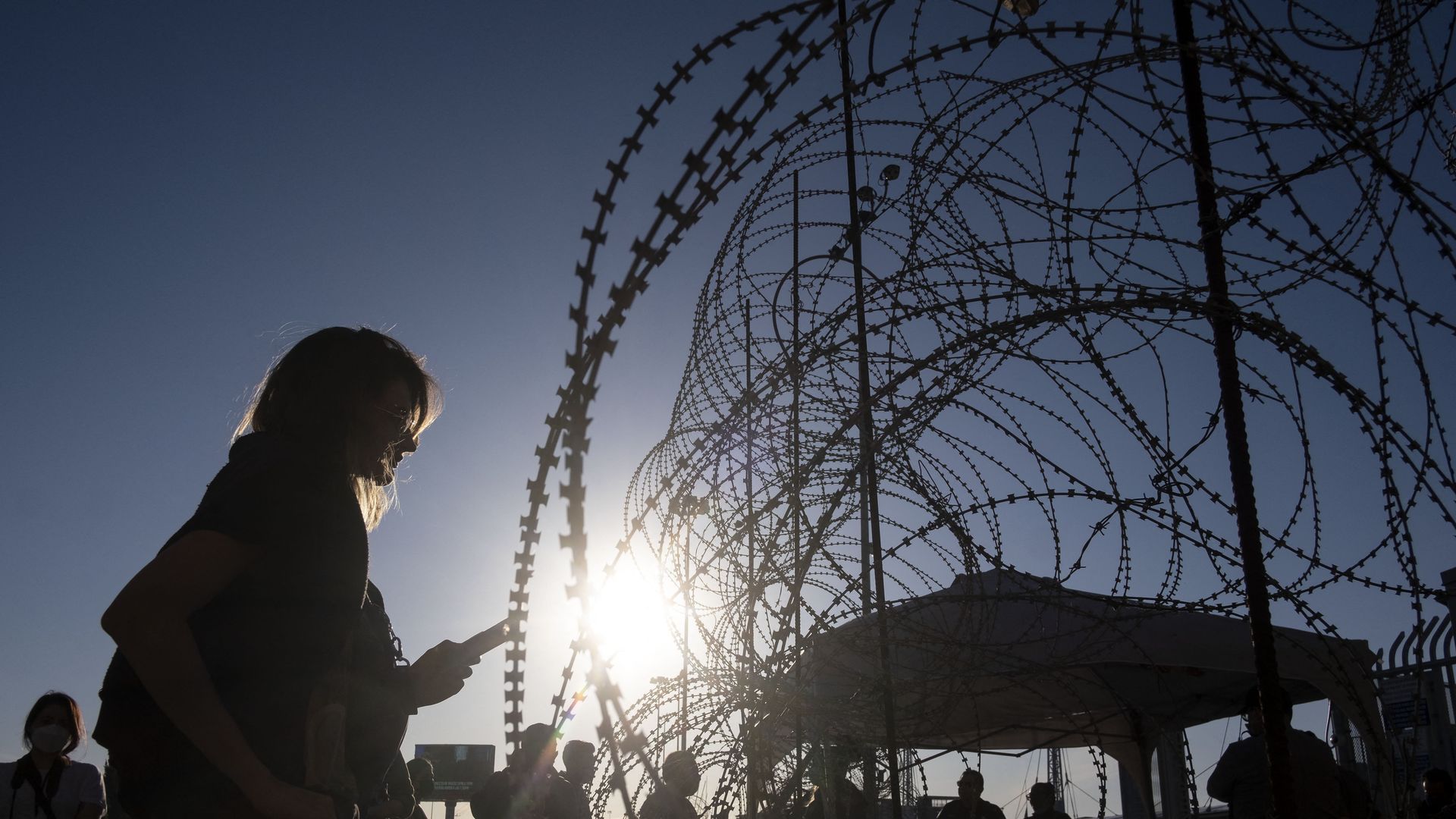 An asylum seeker from Ukraine waits with other asylum seeker from her country for US border authorities to allow them in on the Mexican side of the San Ysidro Crossing port