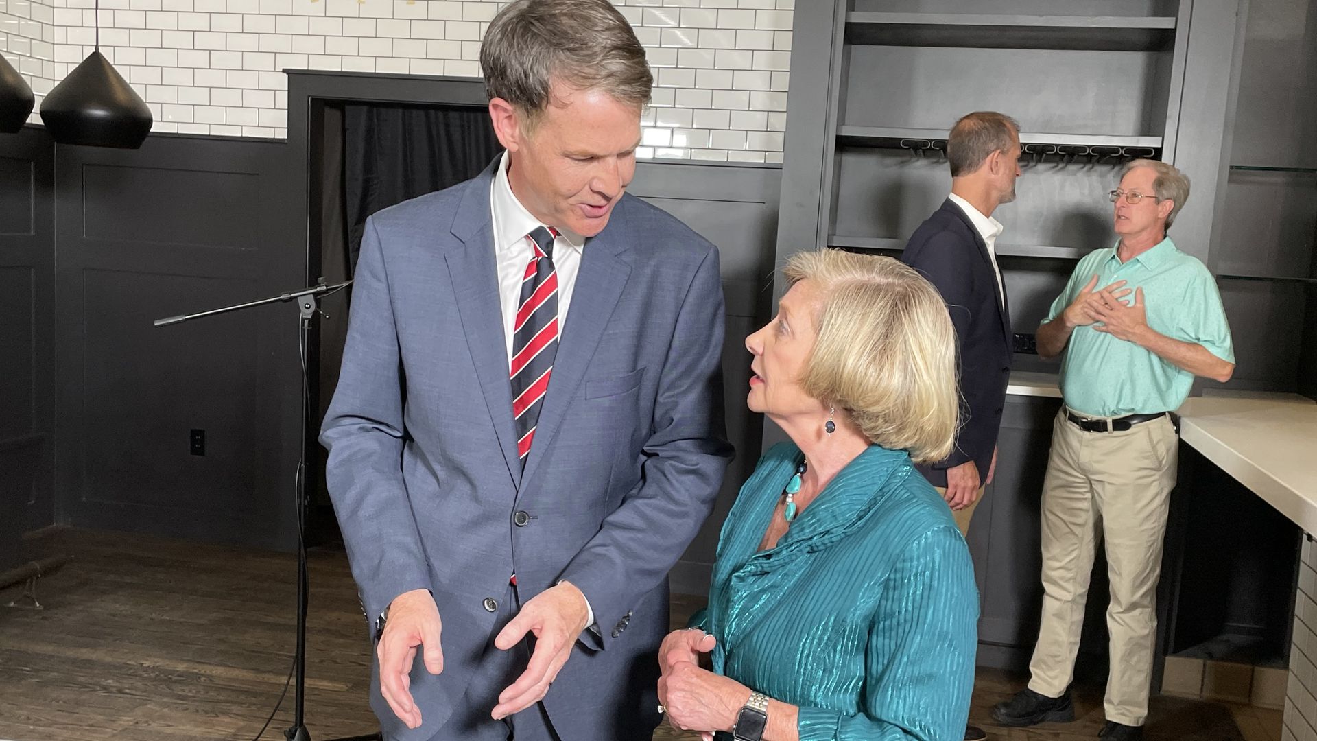 Jefferson Shreve talks to a woman after a press conference in a Broad Ripple bar.