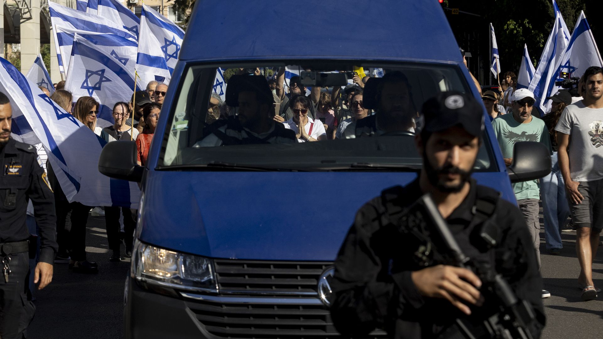 Man with gun, people with flags