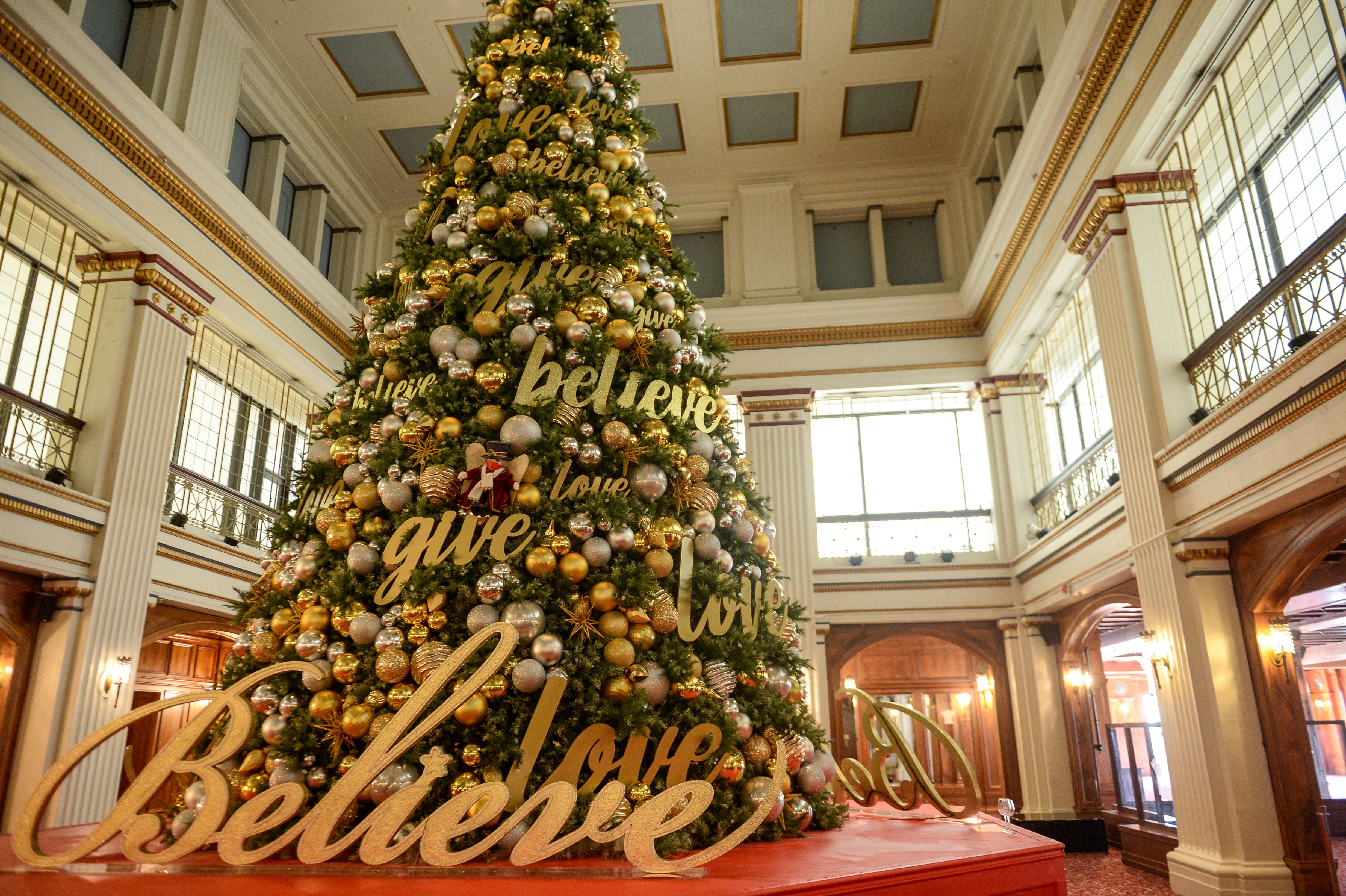 Photo of a decorated Christmas tree inside of a restaurant 