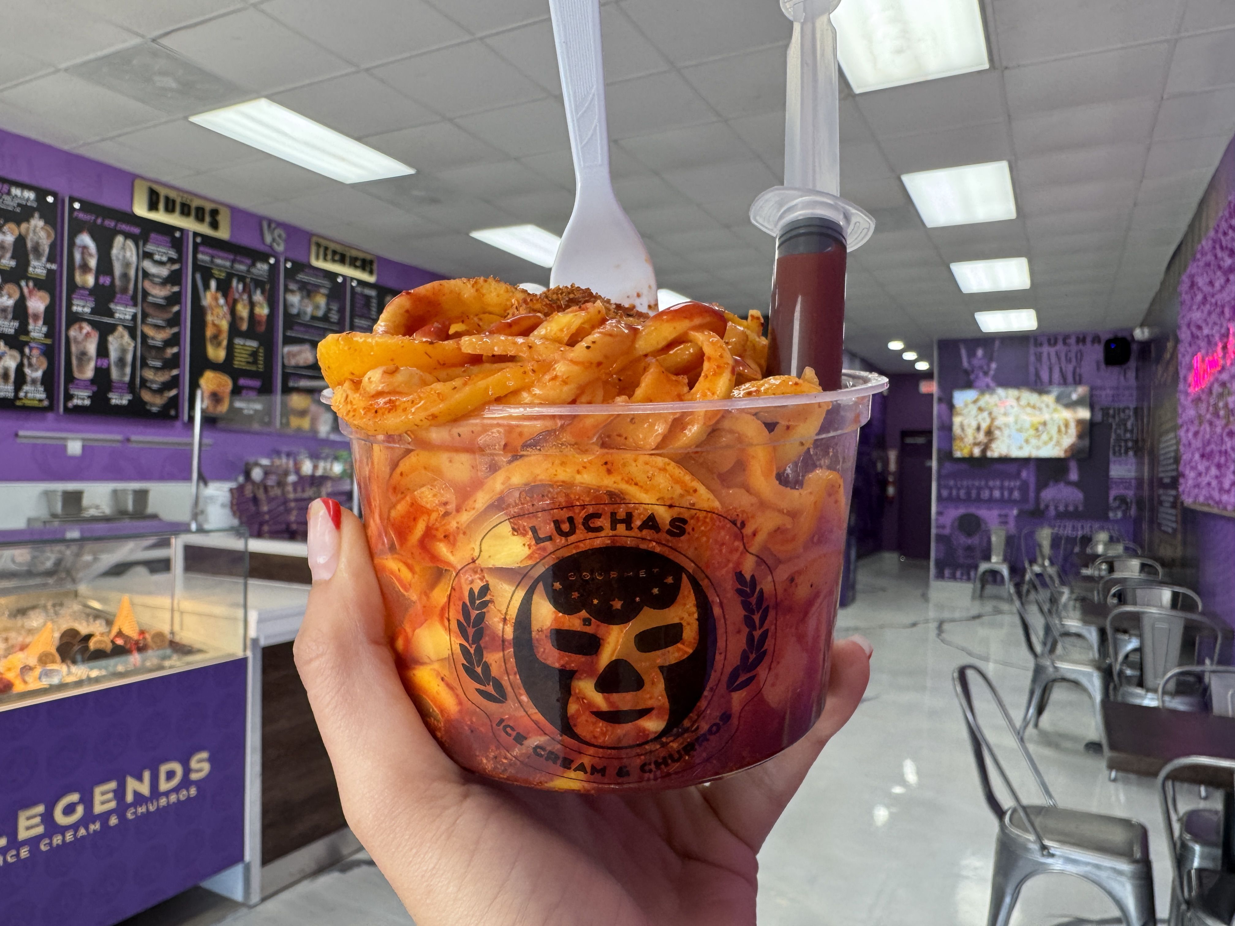 hand holding cup full of mango