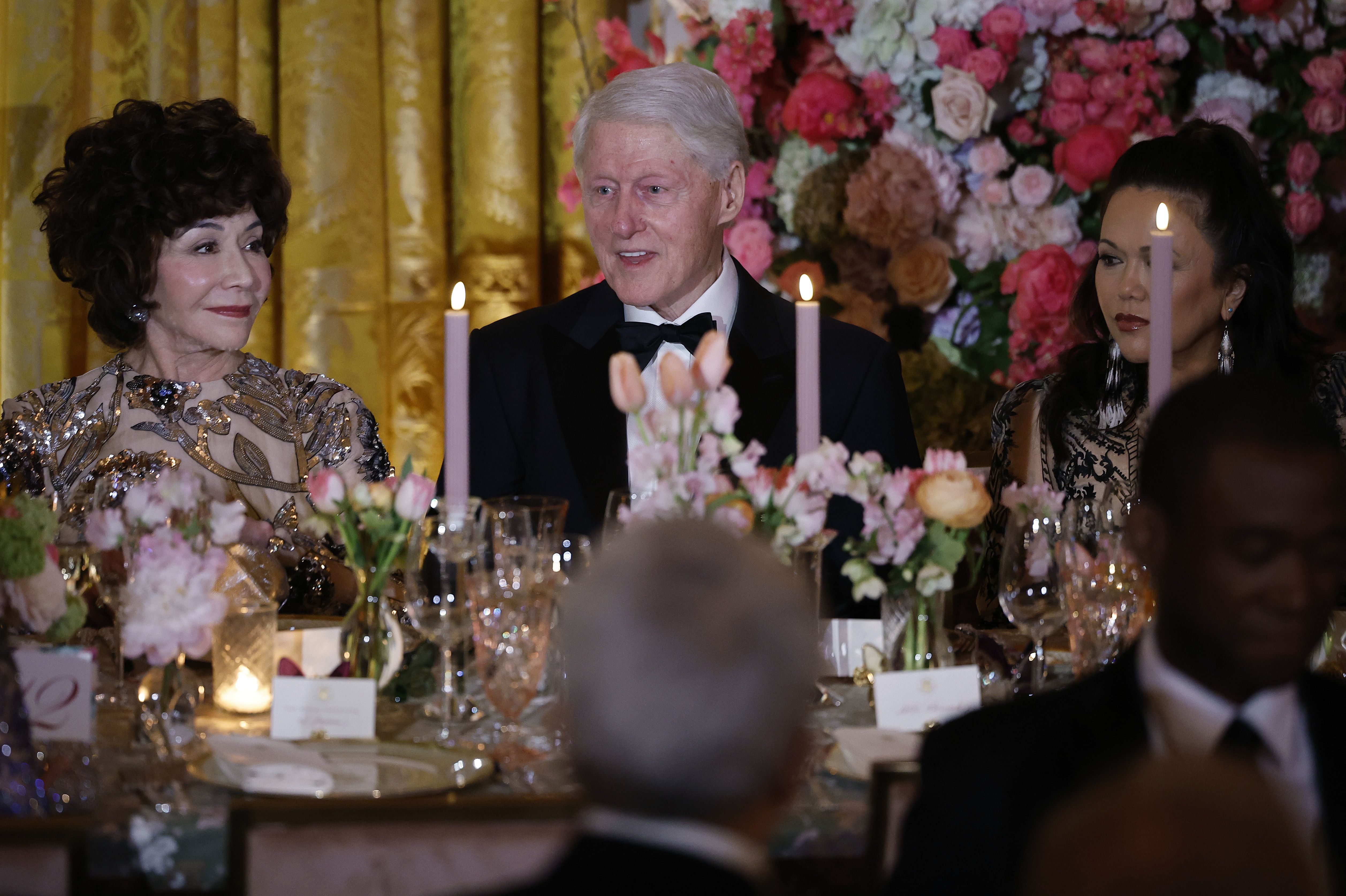  Former U.S. President Bill Clinton (C) joins other guests for a state dinner in honor of Japanese Prime Minister Fumio Kishida in the East Room of the White House for a state dinner on April 10, 2024 in Washington, DC. Biden welcomed Kishida for an official state visit where the two leaders announced new agreements on technology and strengthening military and economic partnerships against Chinese aggression in the Indo-Pacific region. 