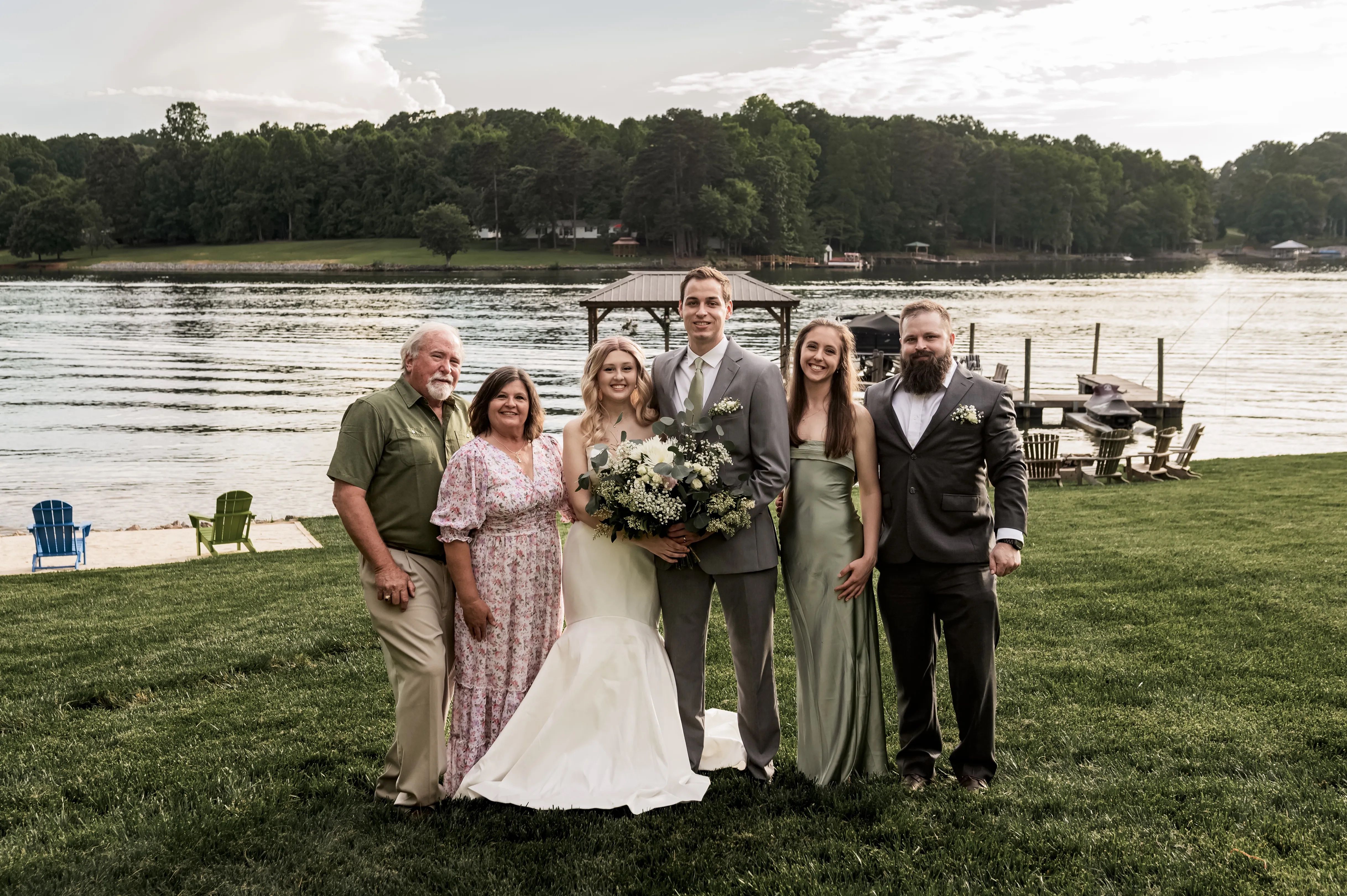 family standing in front of a lake