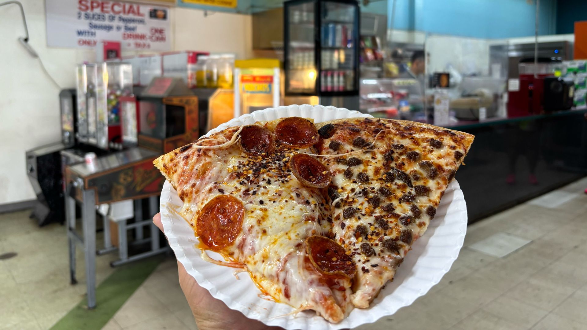 Two slices of pizza on a paper plate
