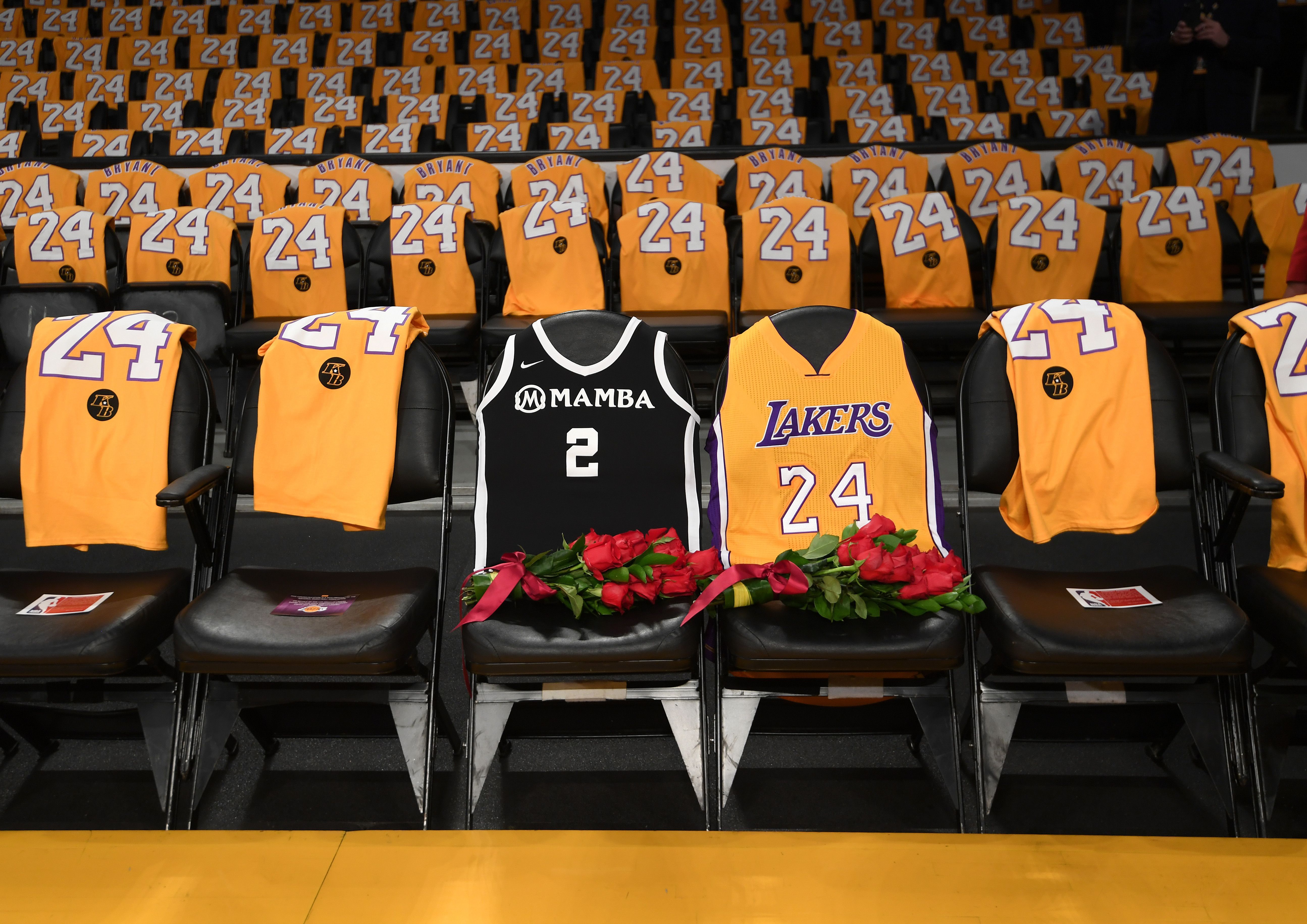 In this image, a line of jerseys sit courtside in Staples Center