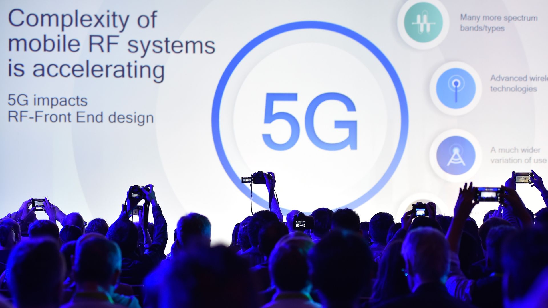 A 5G logo is displayed at an event