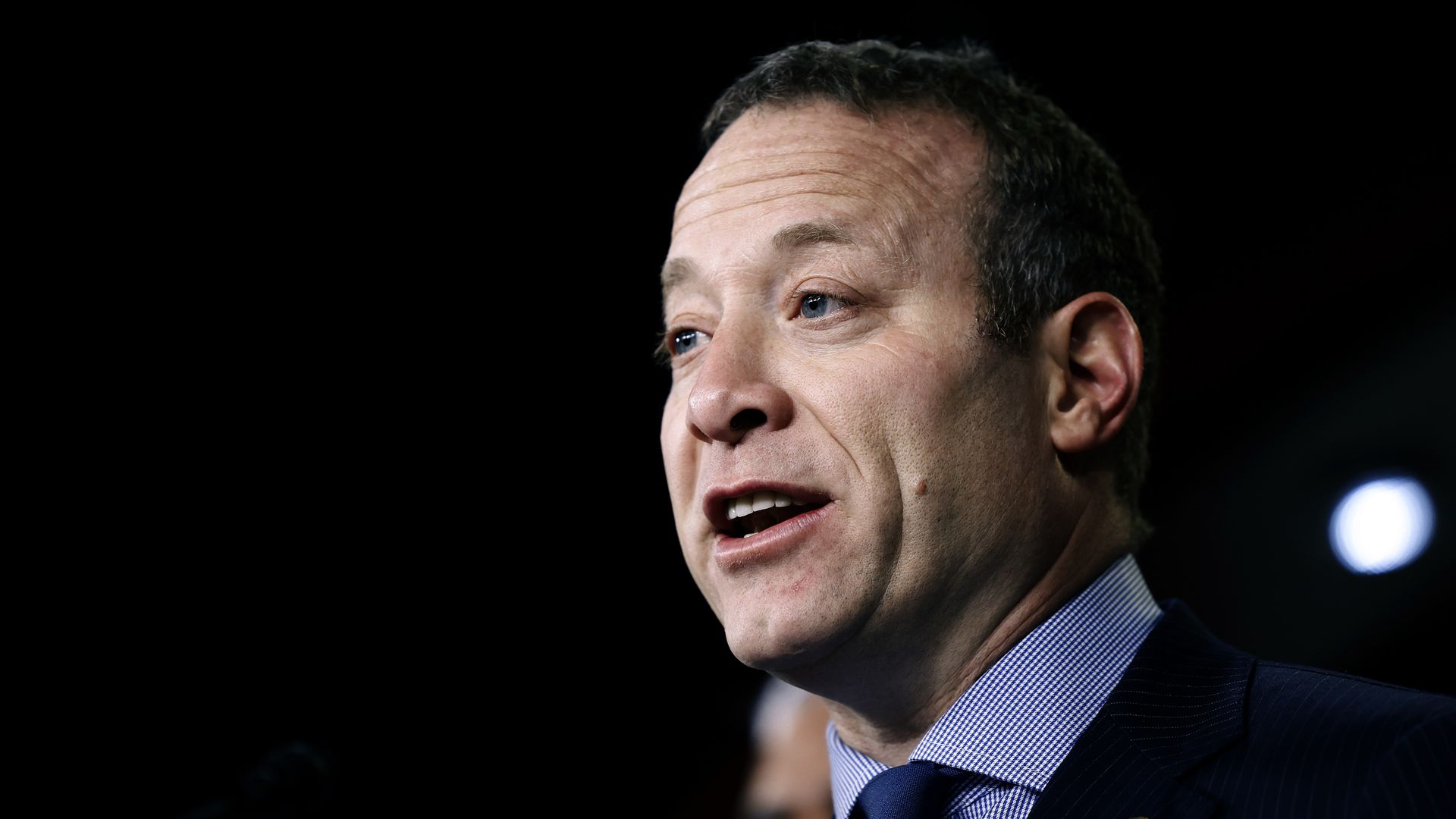 Rep. Josh Gottheimer, wearing a blue suit and speaking in a TV studio.