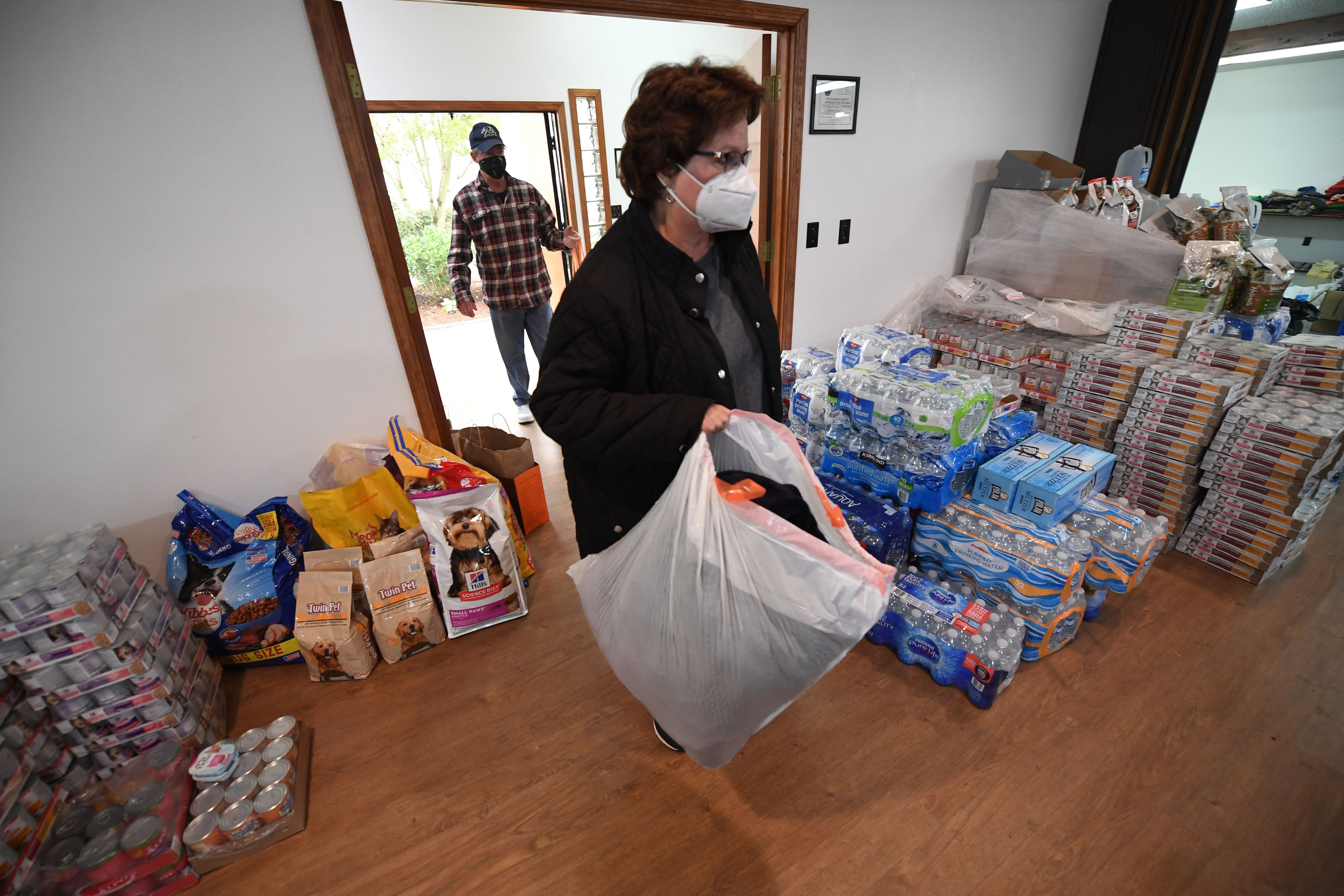 A woman drops off donations for residents evacuated from the Riverside Fire, one of many wildfires burning across the Oregon, at the Clackamas County Fairgrounds in Canby, Oregon, September 13