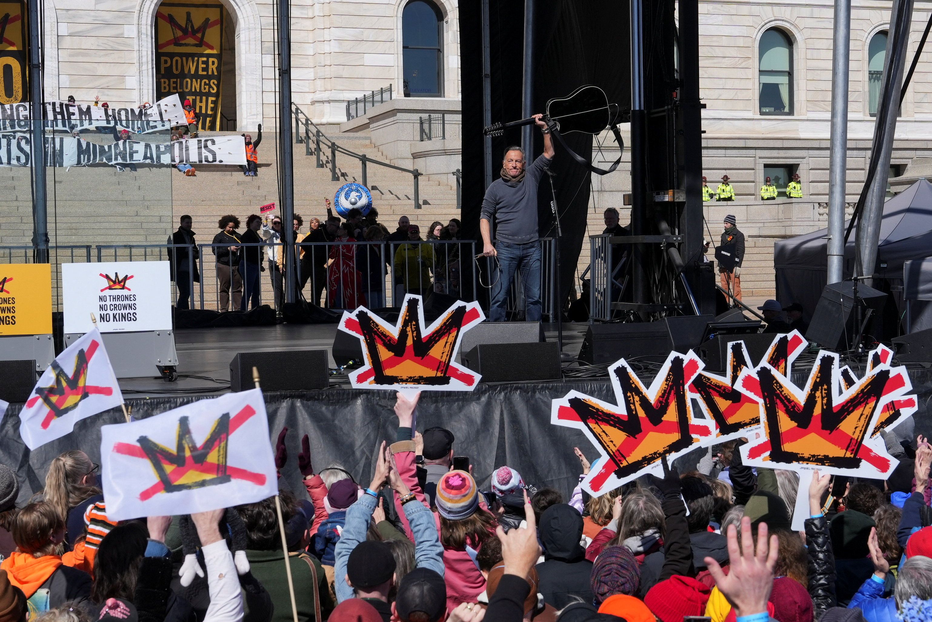 Bruce Springsteen raises his guitar on stage during a "No Kings" protest against U.S. President Donald Trump's administration policies, in St. Paul, Minnesota, March 28, 2026. REUTERS/Tim Evans