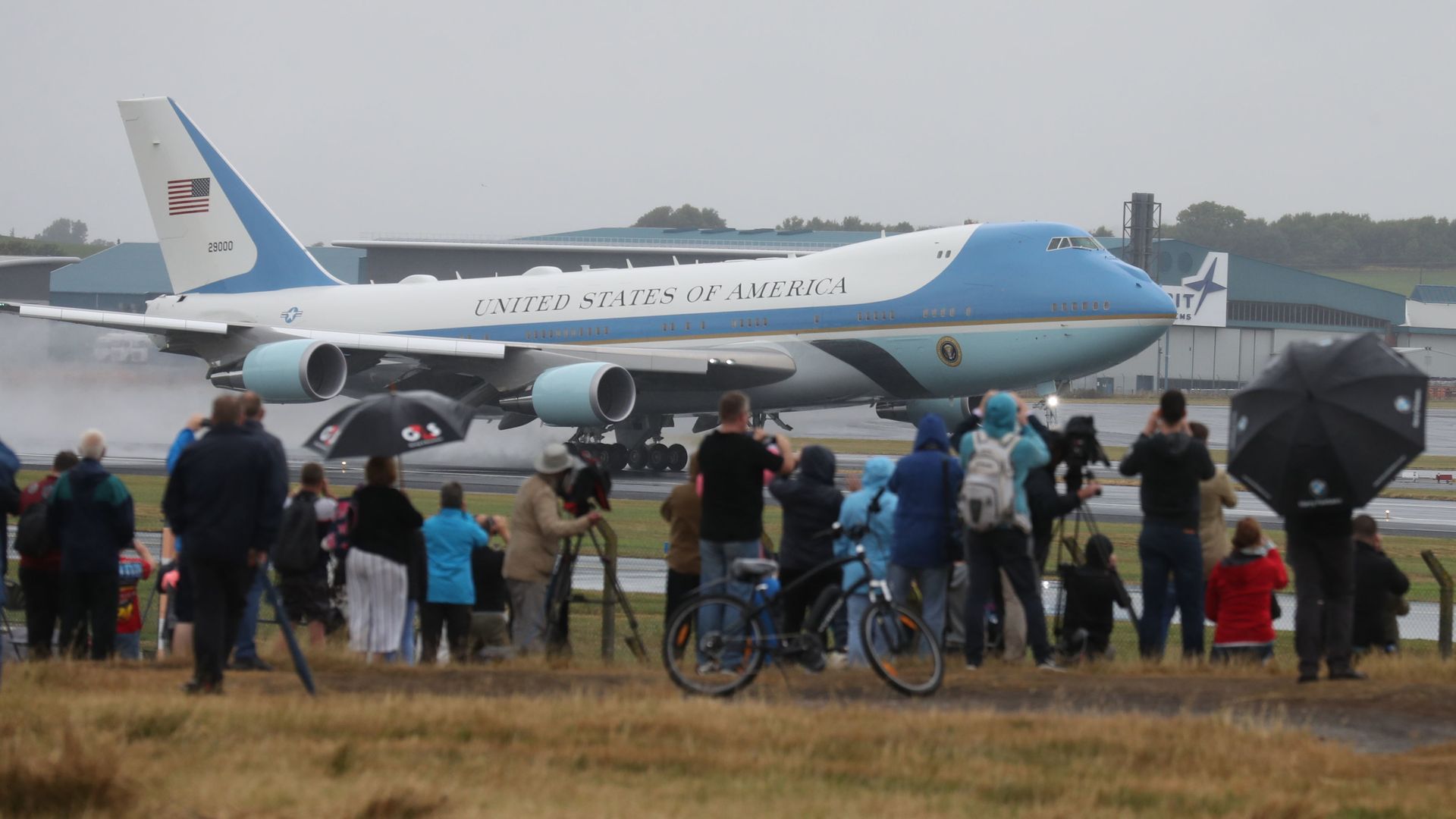 People watch as Air Force One takes off from Prestwick Airport in Ayrshire, as US President Donald Trump and his wife Melania leave the UK