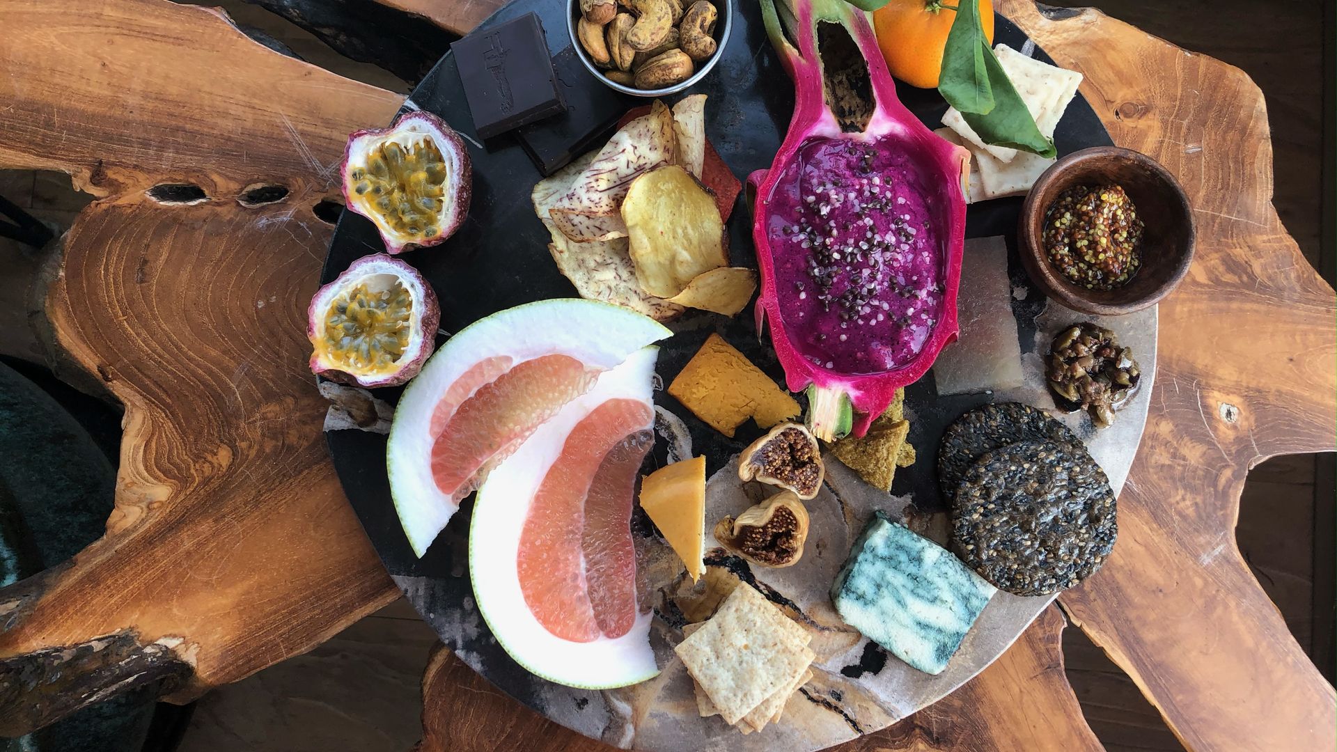 A wooden plate with various fruits.