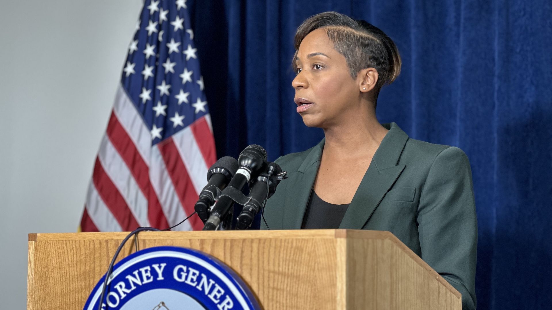Attorney General Andrea Campbell speaking from a podium