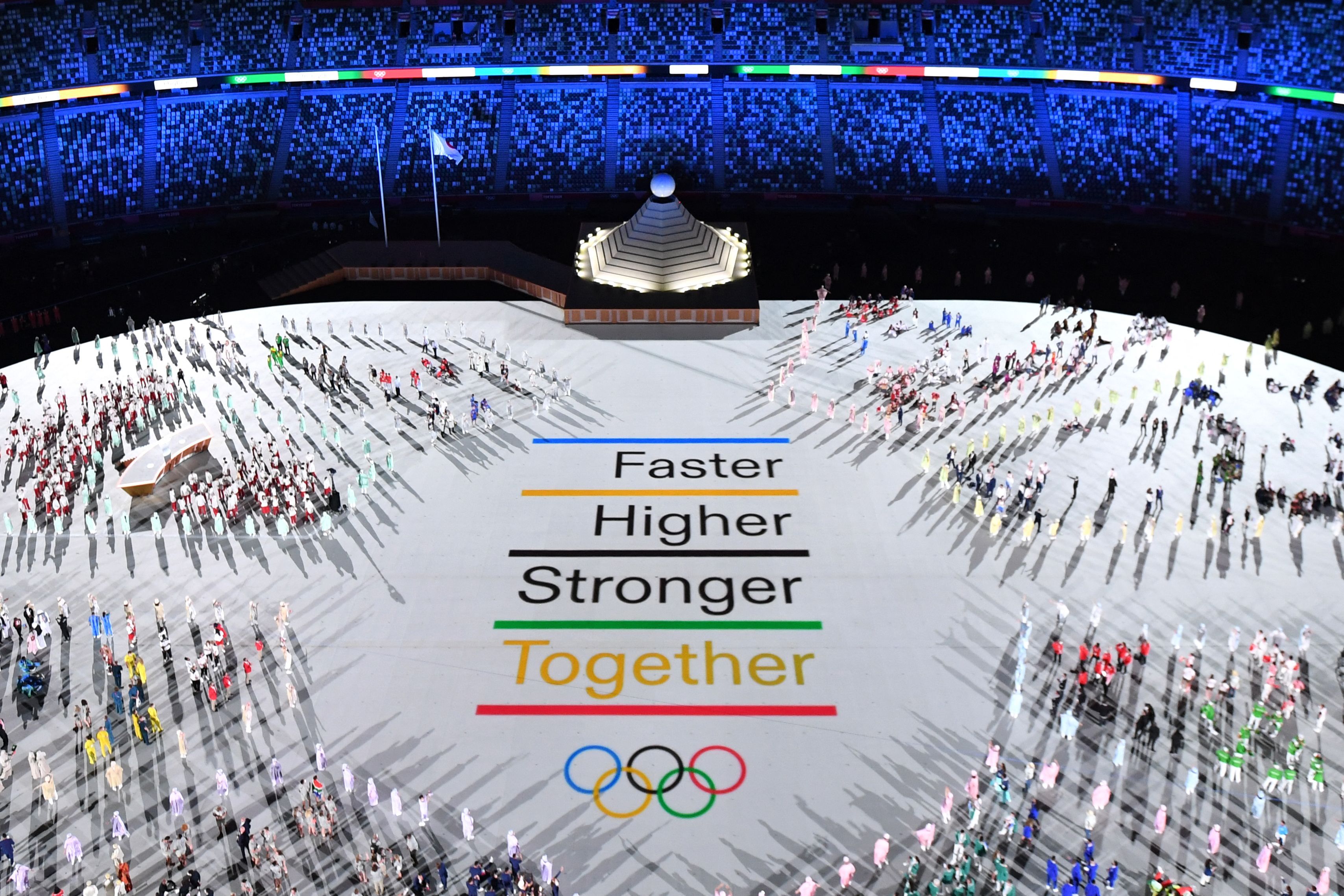 Photo of the Olympic stadium reflecting the Olympic slogan, "Faster, Higher, Stronger, Together."