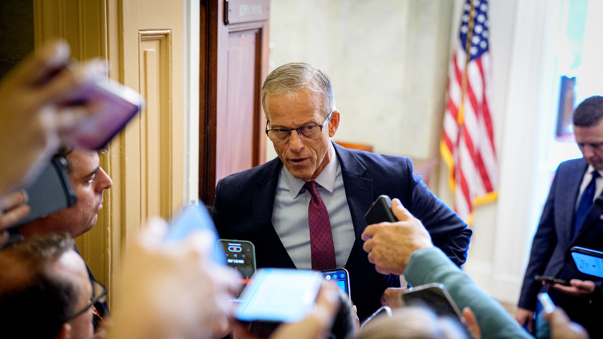 John Thune speaks to reporters in a hallway of the Capitol.