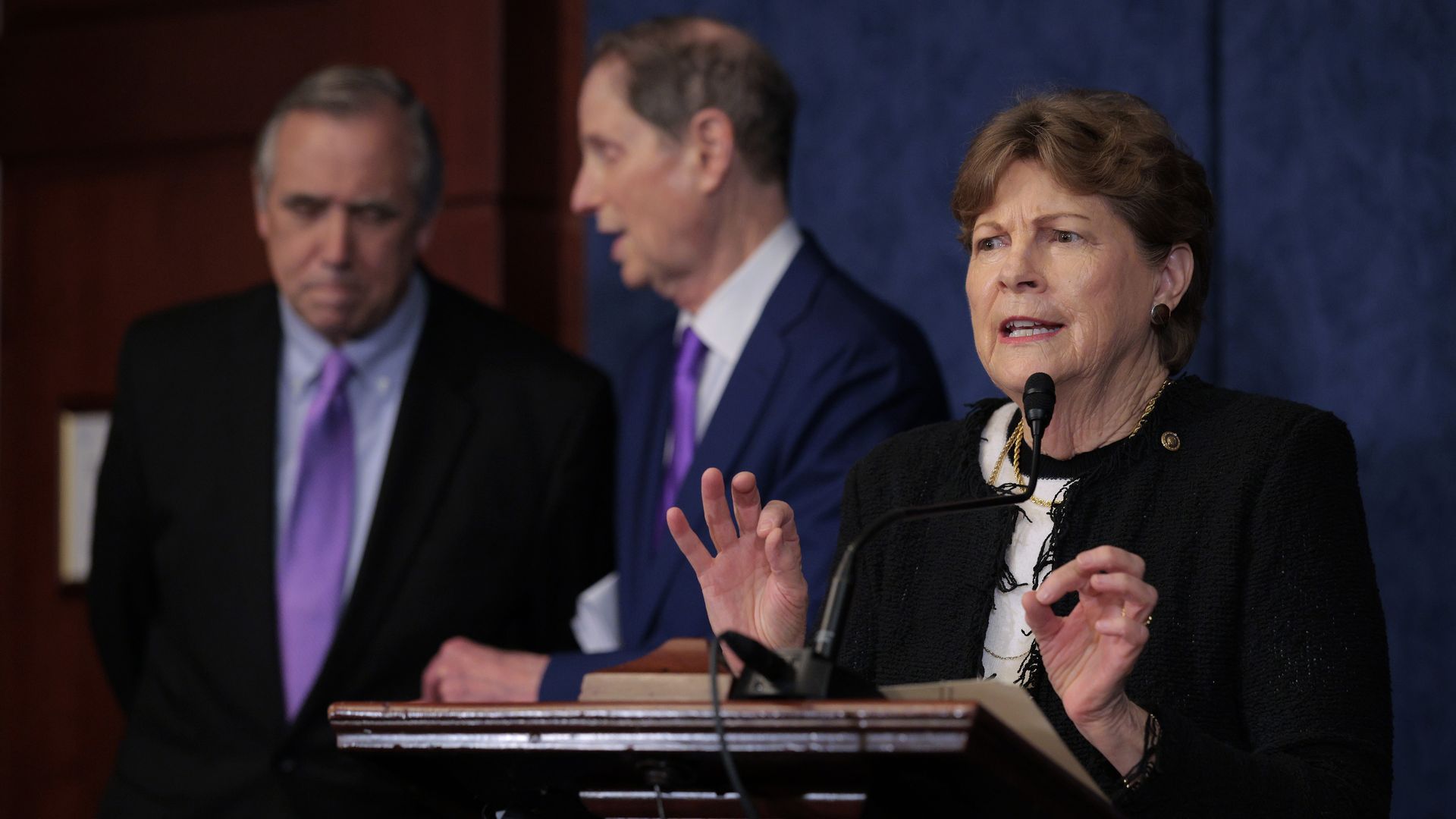Sen. Jeanne Shaheen at a podium, gesticulating with her hands