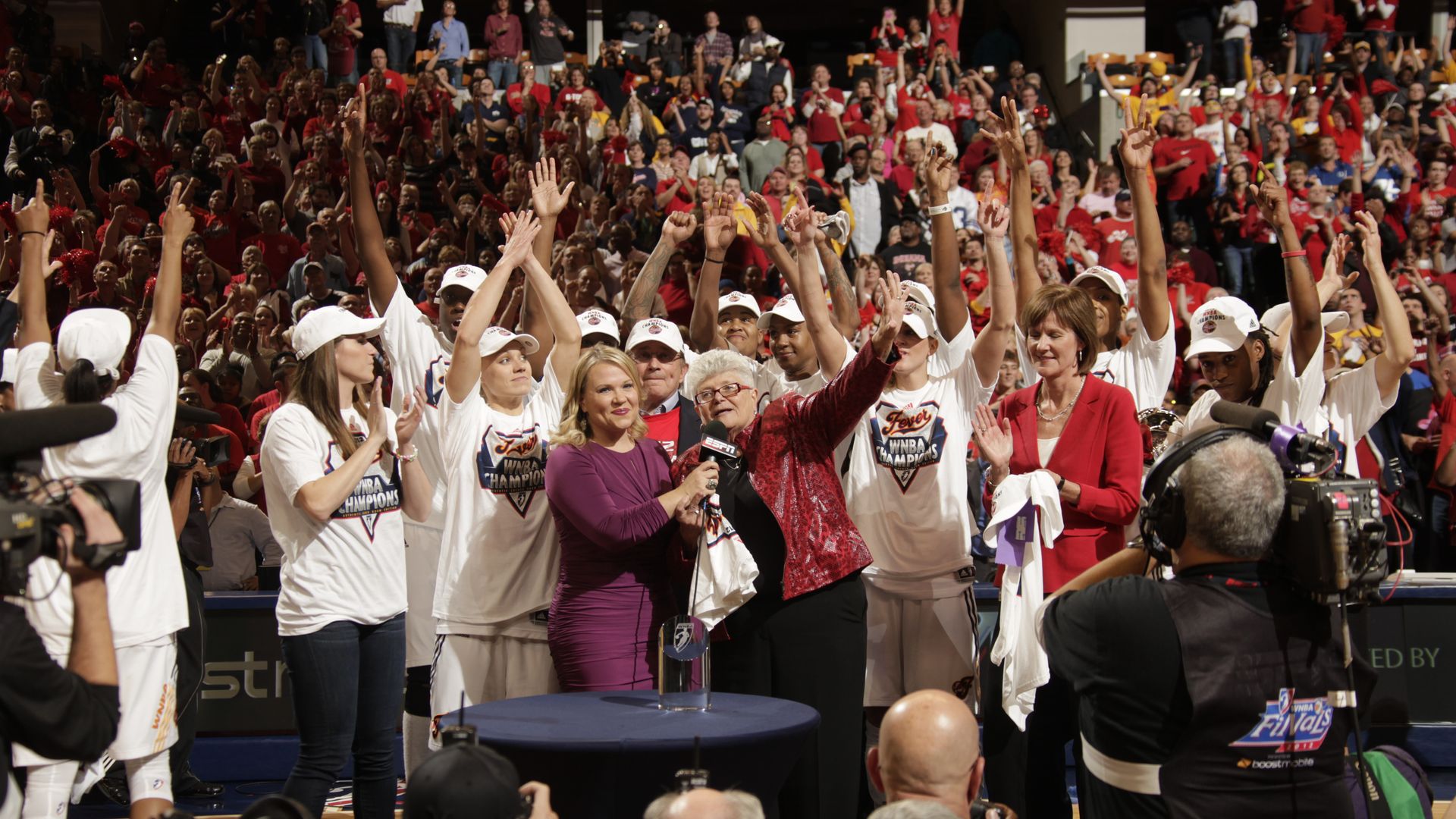 Holly Rowe of ESPN interviews Head Coach Lin Dunn of the Indiana Fever with the Championship Trophy after defeating the Minnesota Lynx during Game four of the 2012 WNBA Finals