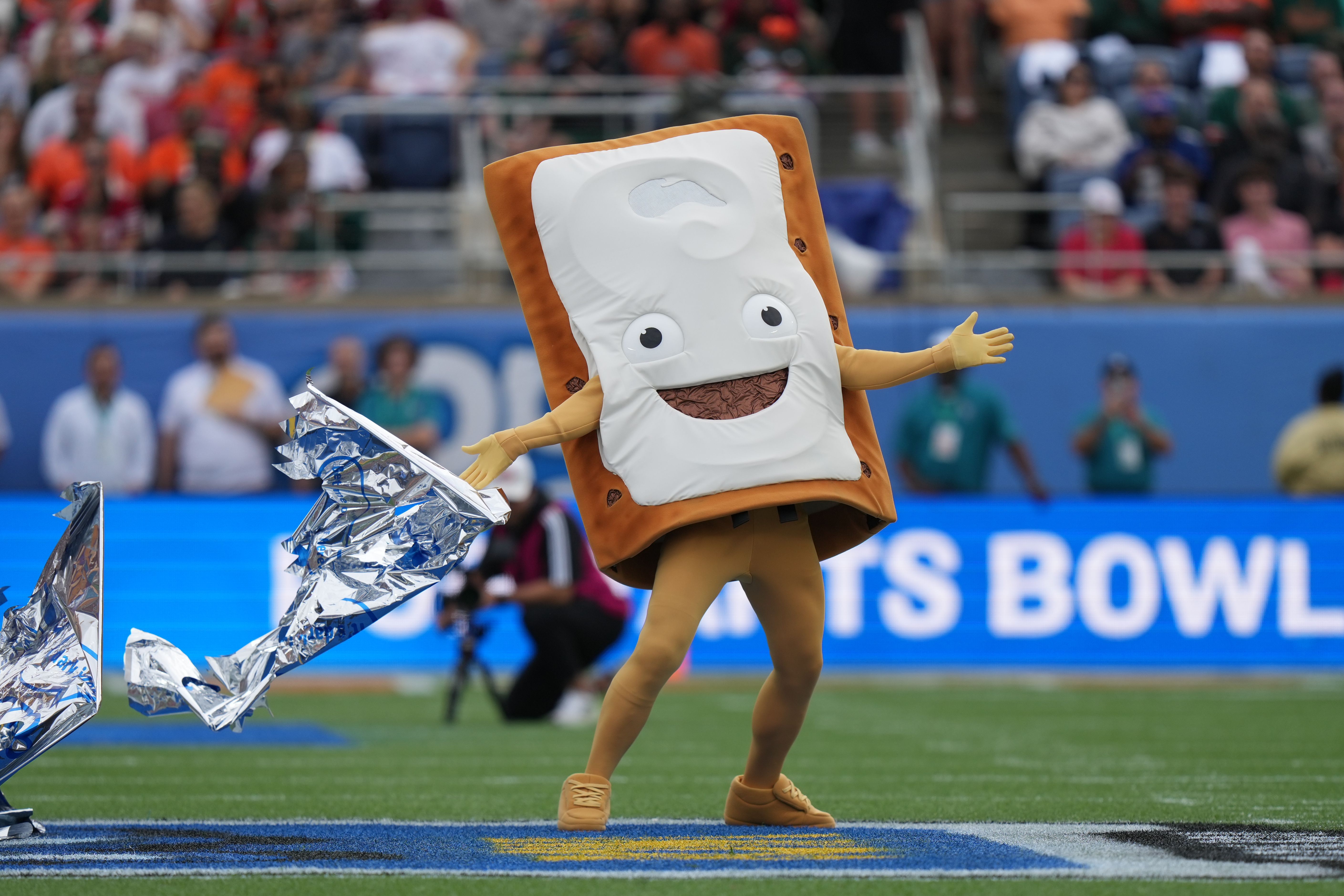 a Pop-tart mascot reveals his flavor before the Pop-Tarts Bowl game between the Iowa State Cyclones and the Miami Hurricanes on Saturday, December 28, 2024 at Camping World Stadium in Orlando, Fla. (Photo by Peter Joneleit/Icon Sportswire via Getty Images)
