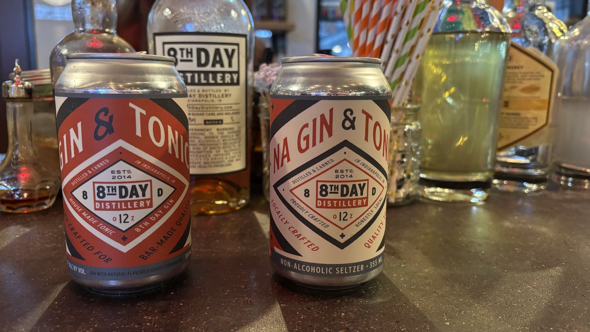 Two cans sitting on a bar